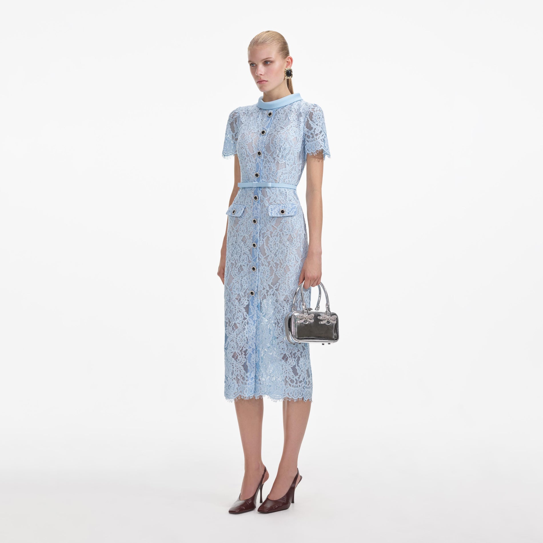 Side view of a woman wearing the Blue Lace Button Midi Dress