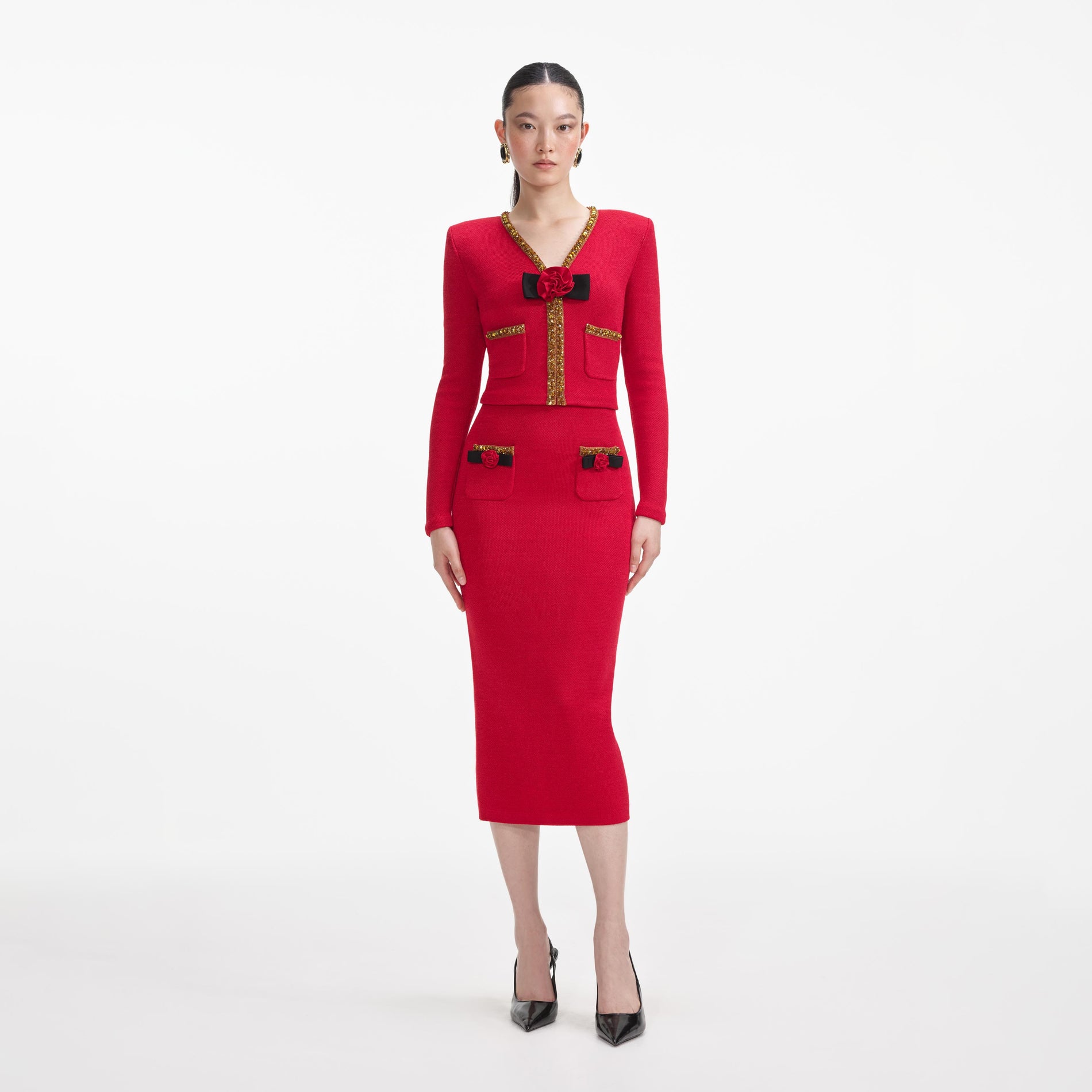 Front view of a woman wearing the Red Textured Knit Corsage Midi Skirt