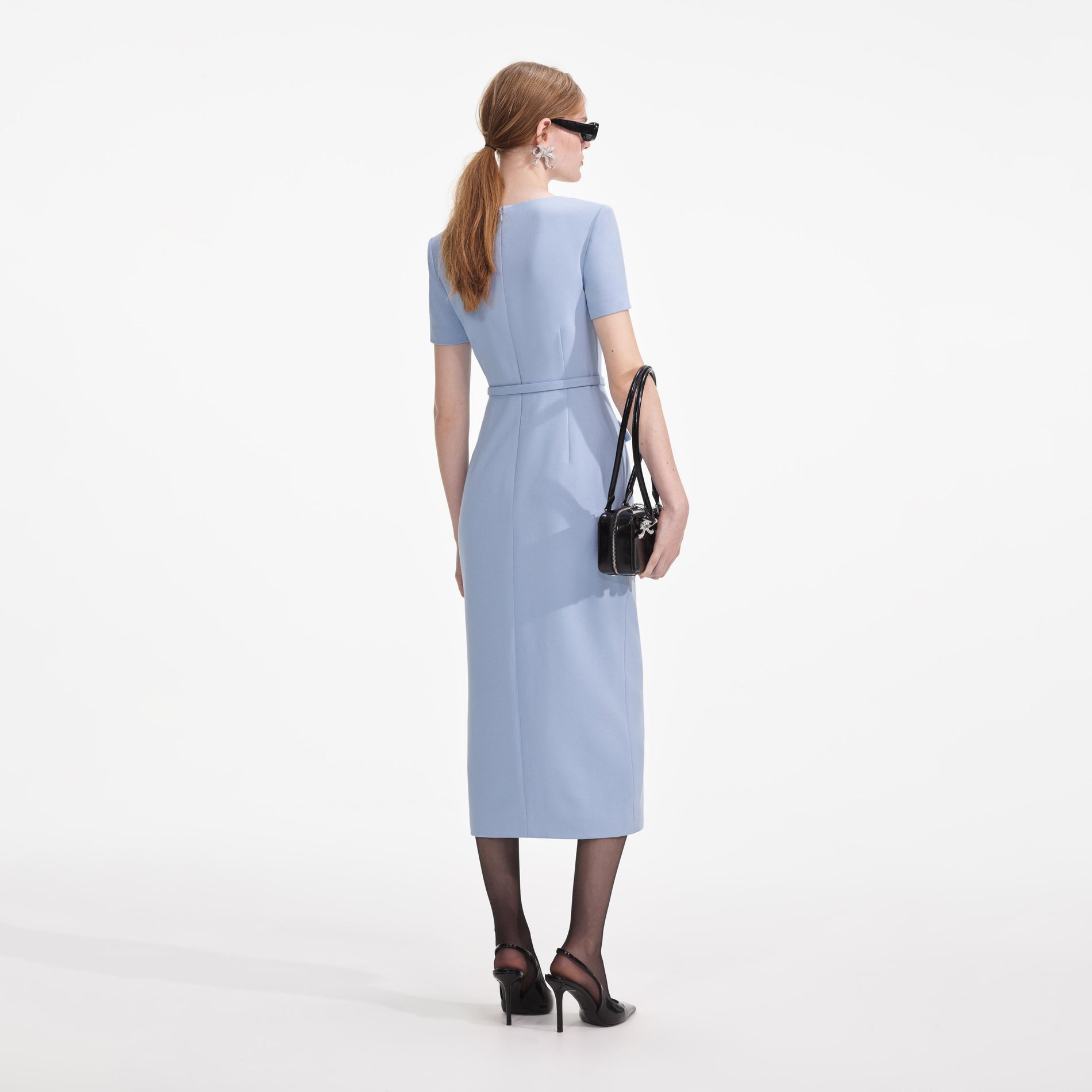 Back view of a woman wearing the Blue Crepe Button Midi Dress