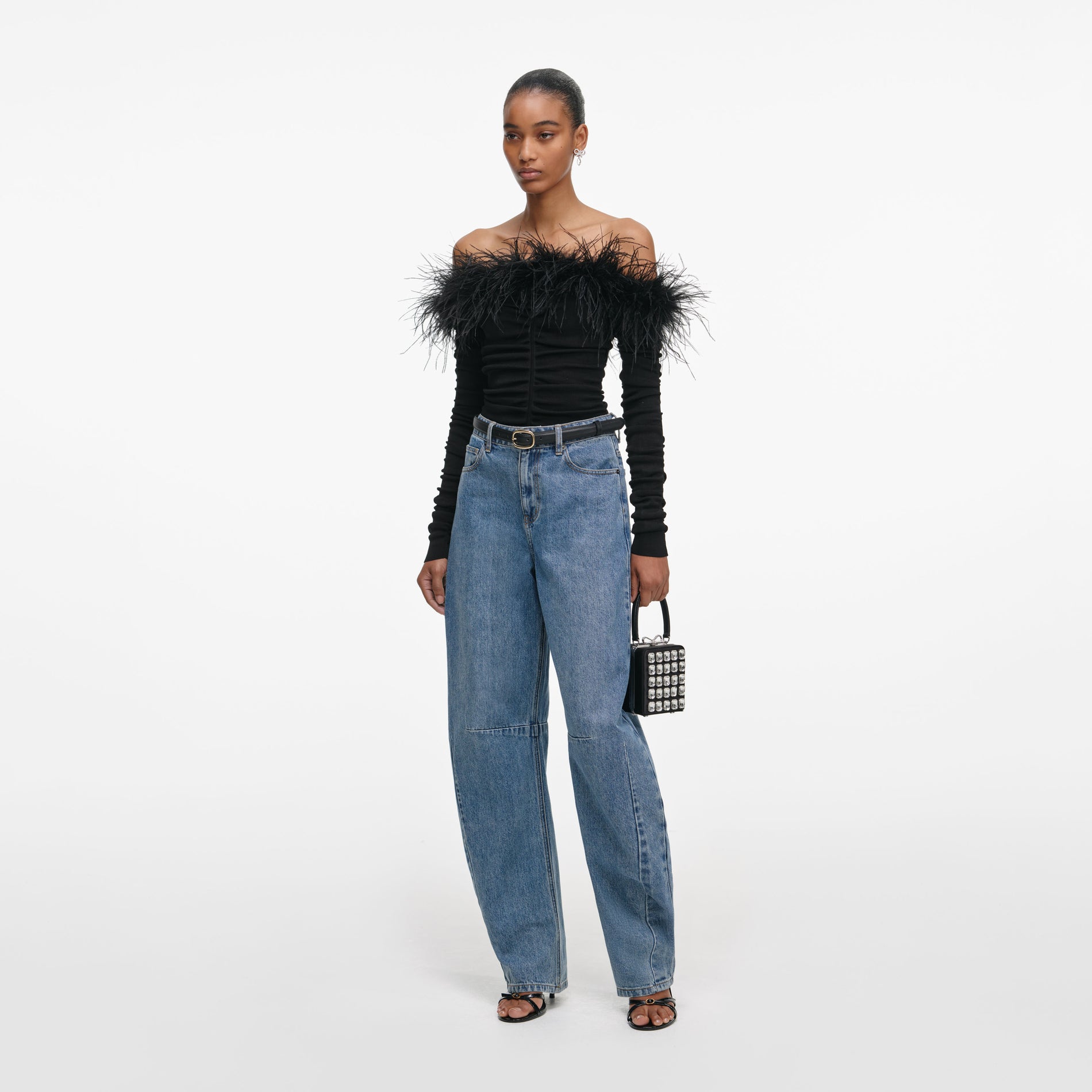 Side view of a woman wearing the Black Feather Viscose Knit Top