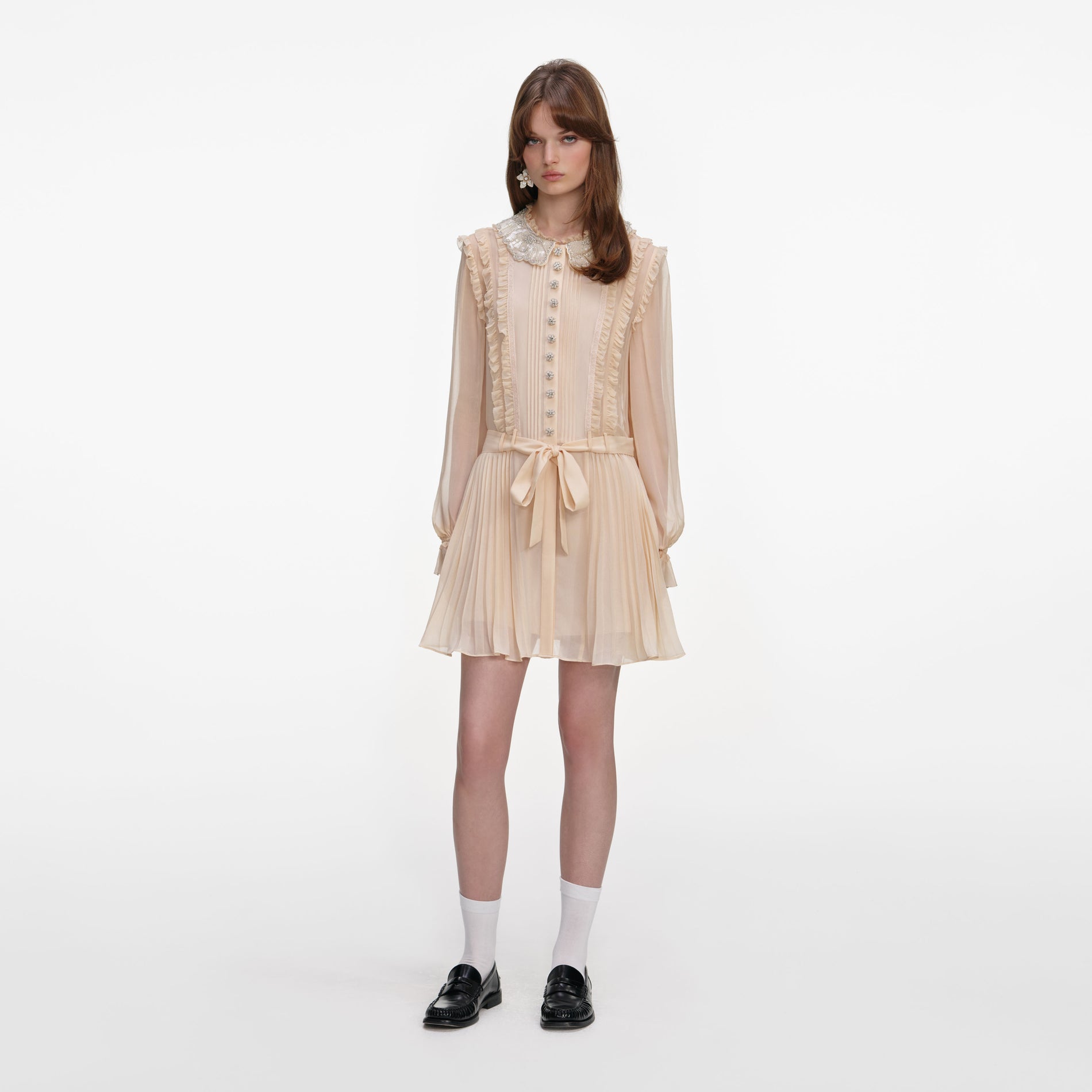 Front view of a woman wearing the Tan Pleated Georgette Mini Dress