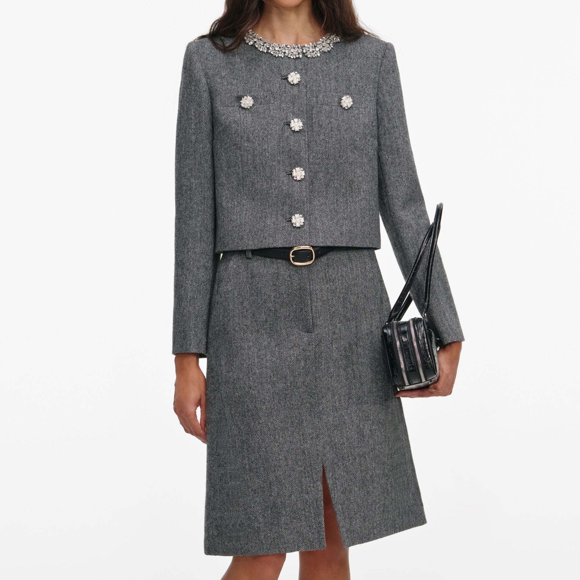 A close up of a woman wearing the Grey Herringbone Crystal Trim Jacket