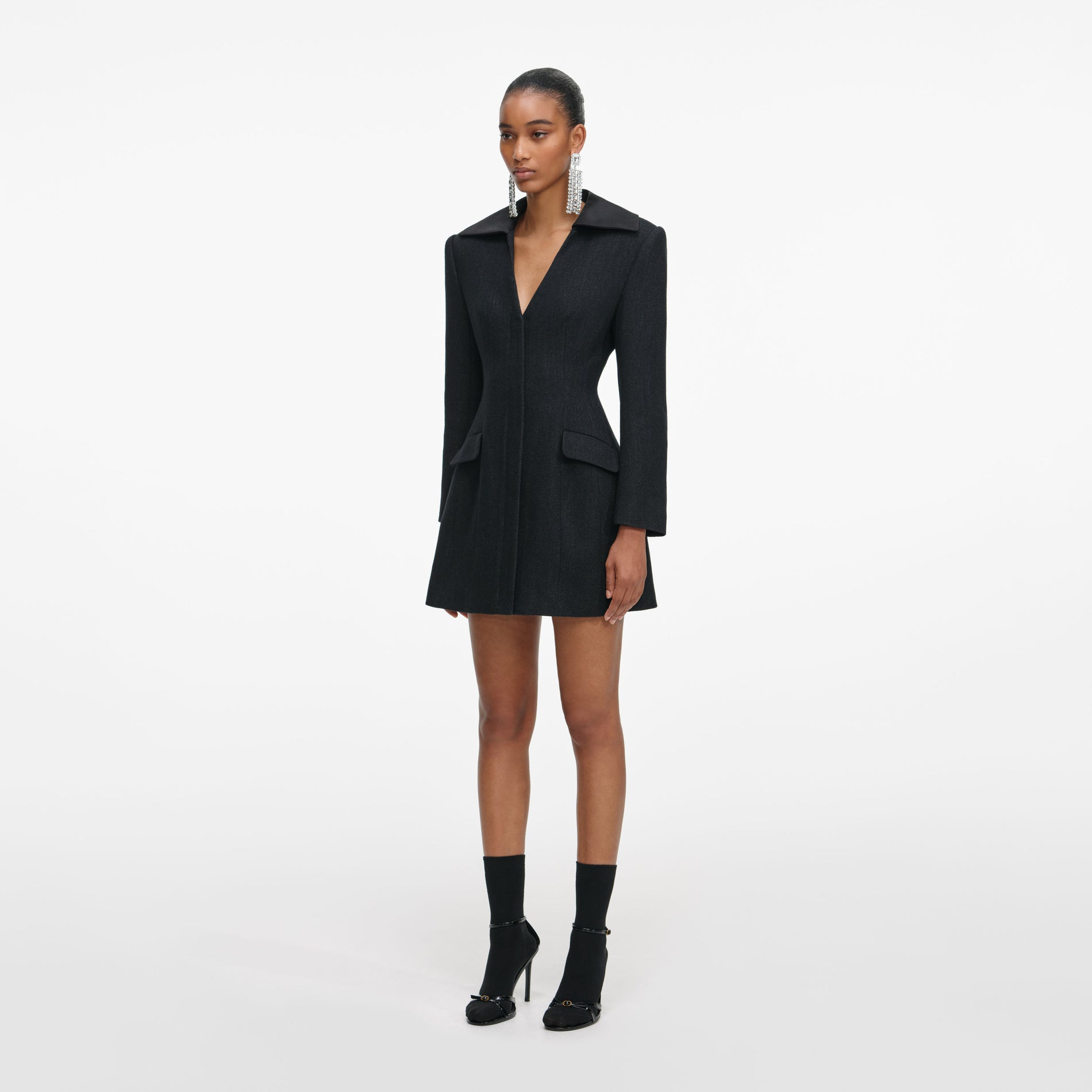 Side view of a woman wearing the Black Blazer Mini Dress