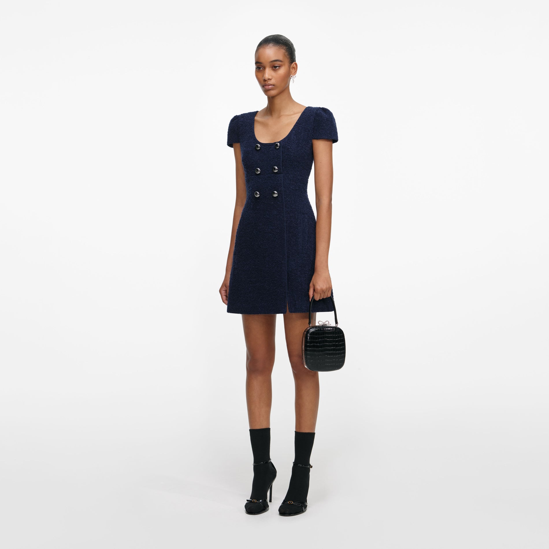 Side view of a woman wearing the Navy Textured Boucle Mini Dress