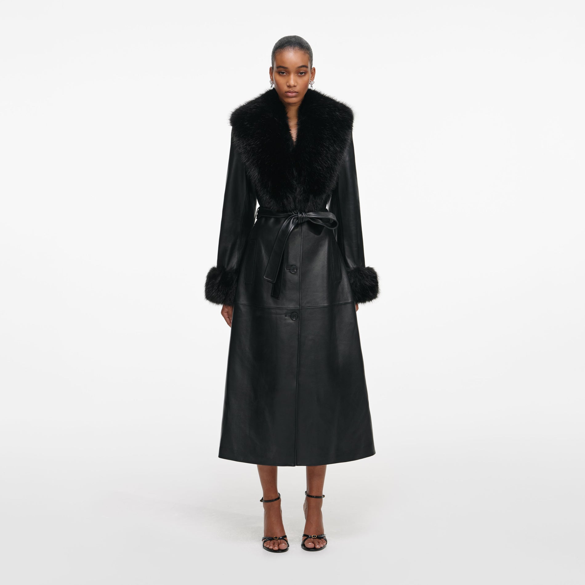 Front view of a woman wearing the Black Leather Faux Fur Collared Coat