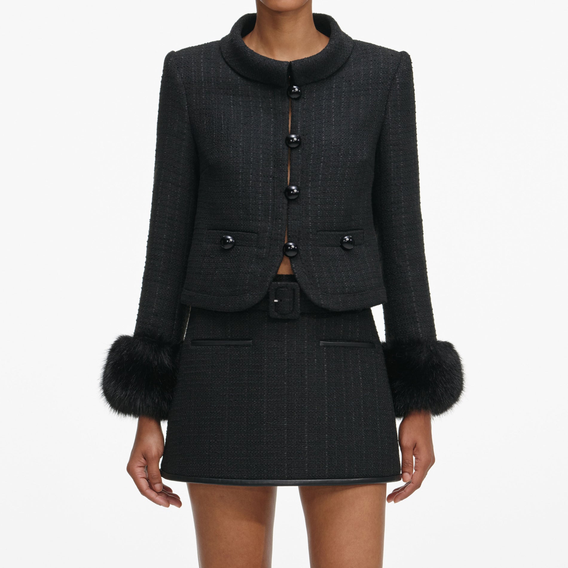A close up of a woman wearing the Black Boucle Faux Fur Cuff Jacket