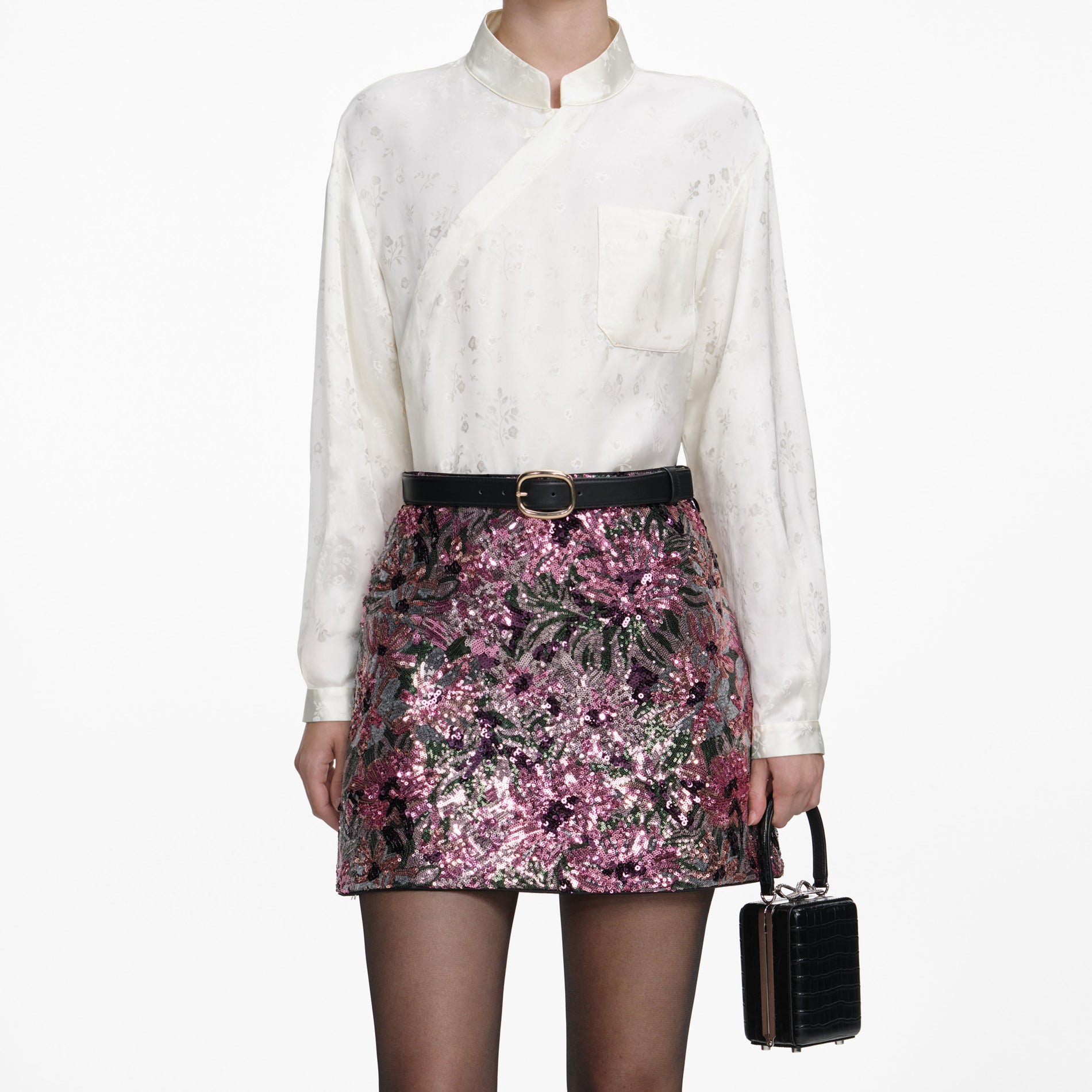 A close up of a woman wearing the Floral Sequin Mini Skirt