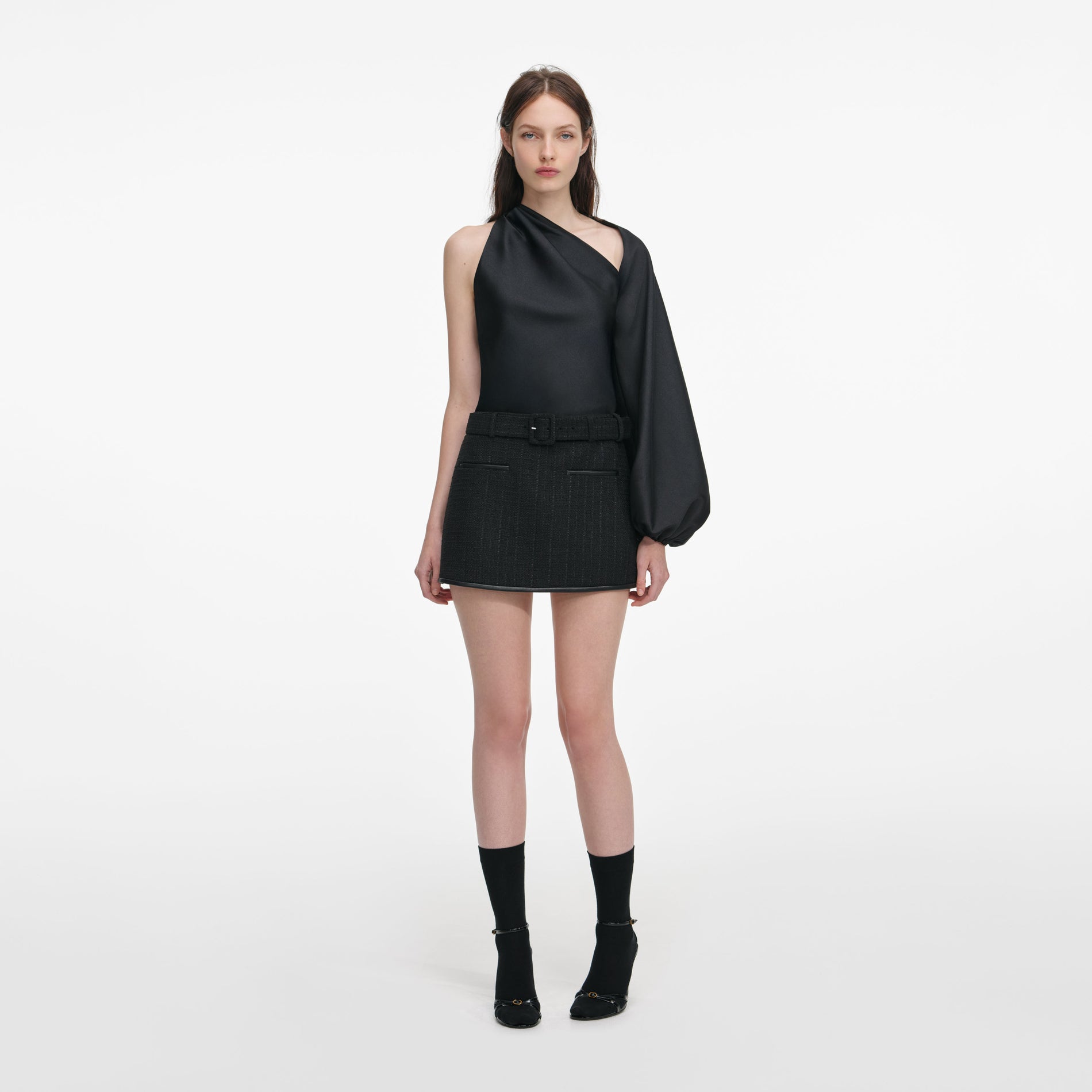 Front view of a woman wearing the Black Boucle Mini Skirt