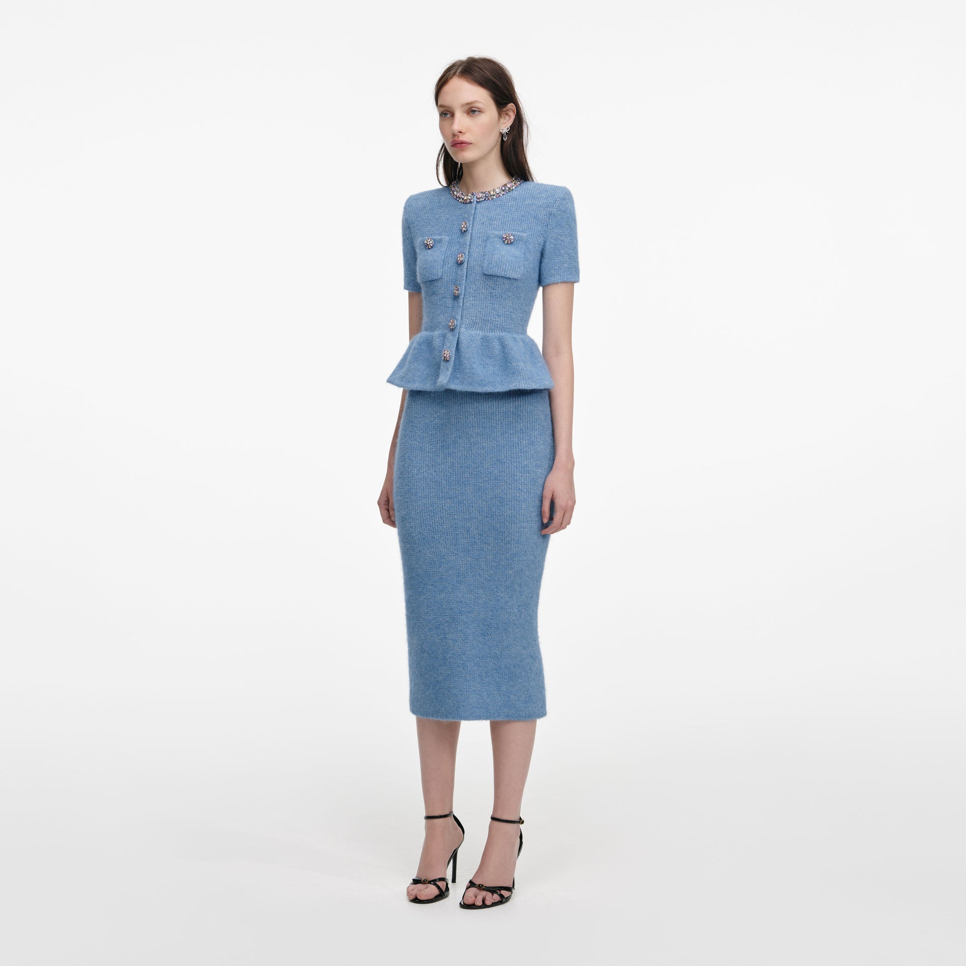 Side view of a woman wearing the Blue Peplum Knit Midi Dress