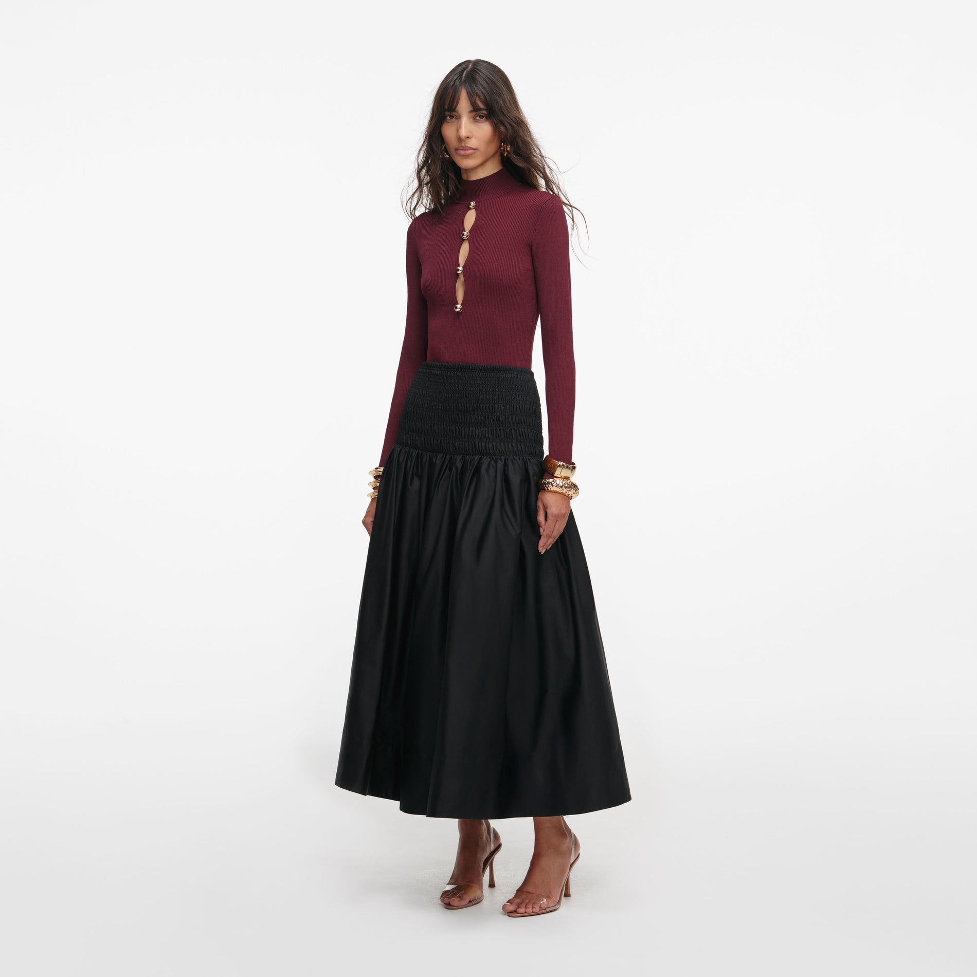 Side view of a woman wearing the Burgundy Keyhole Knit Top