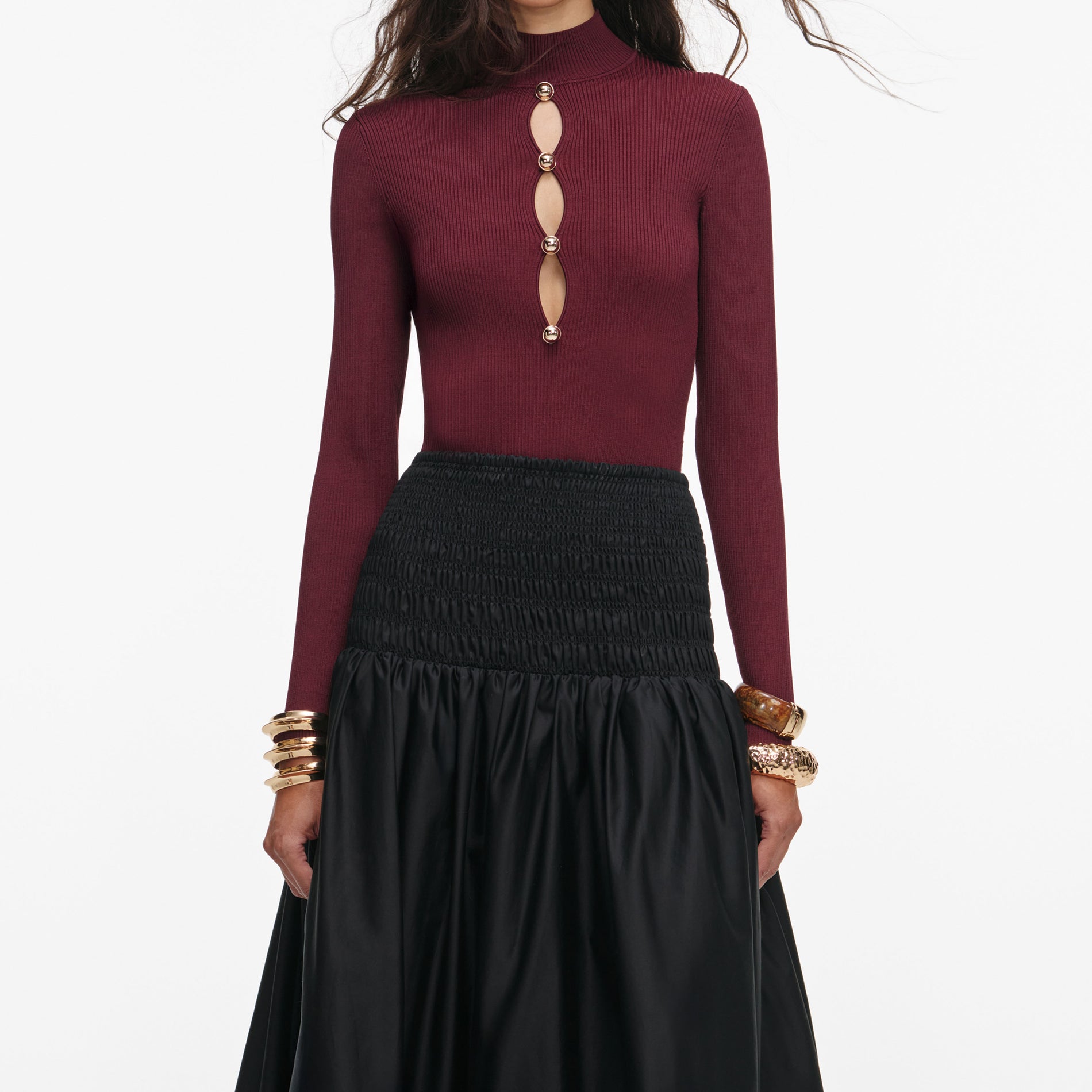 A close up of a woman wearing the Burgundy Keyhole Knit Top