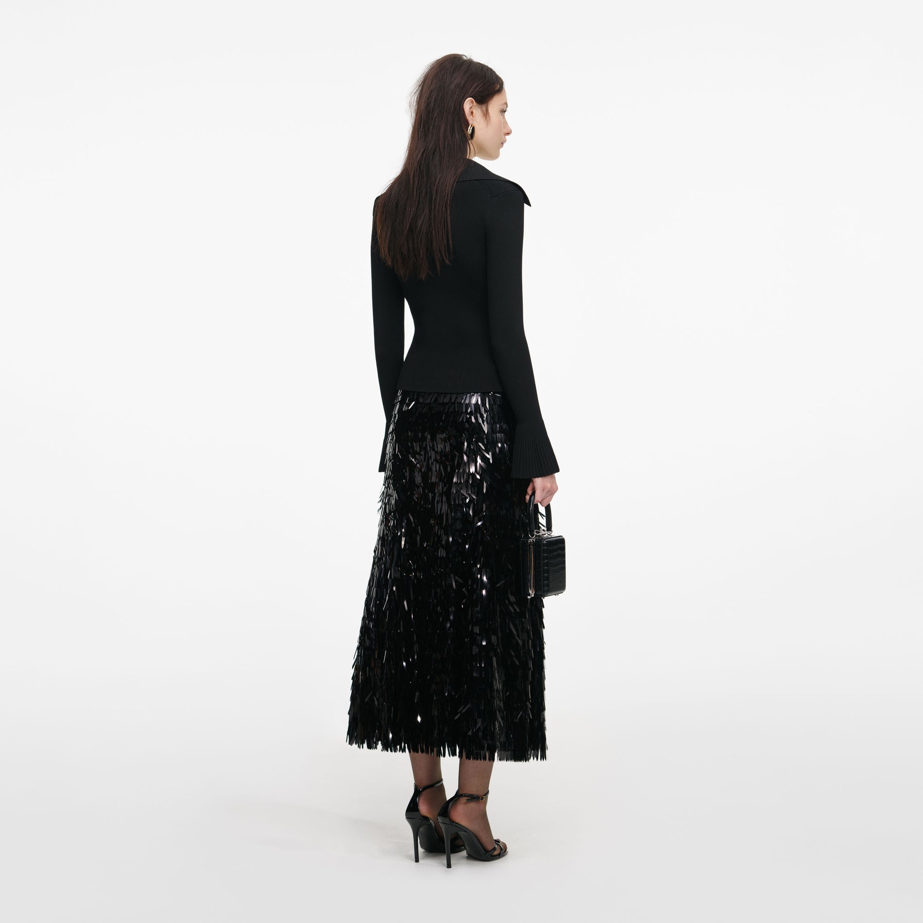 Back view of a woman wearing the Black Button Down Knit Top