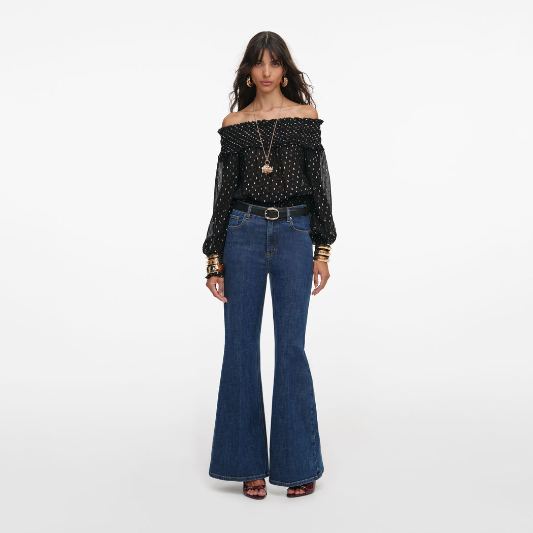Front view of a woman wearing the Black And Gold Chiffon Top