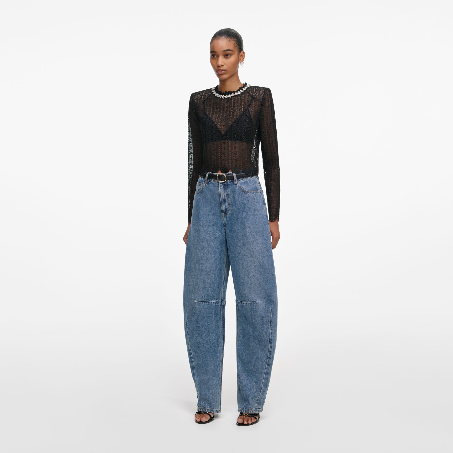 Side view of a woman wearing the Black Organza Lace Top