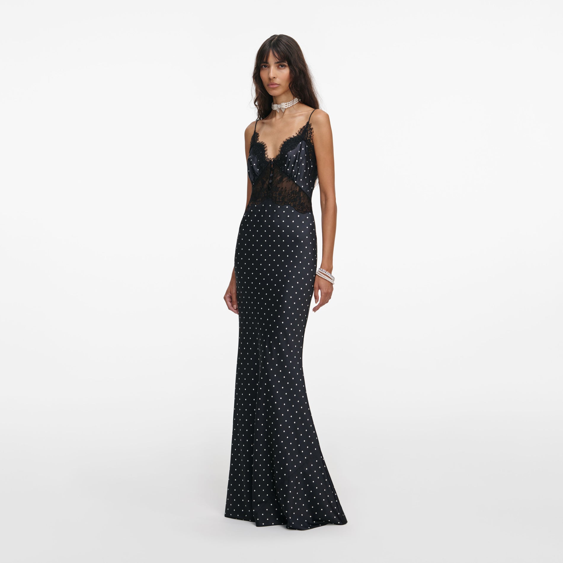Side view of a woman wearing the Polka Dot Satin Lace Maxi Dress