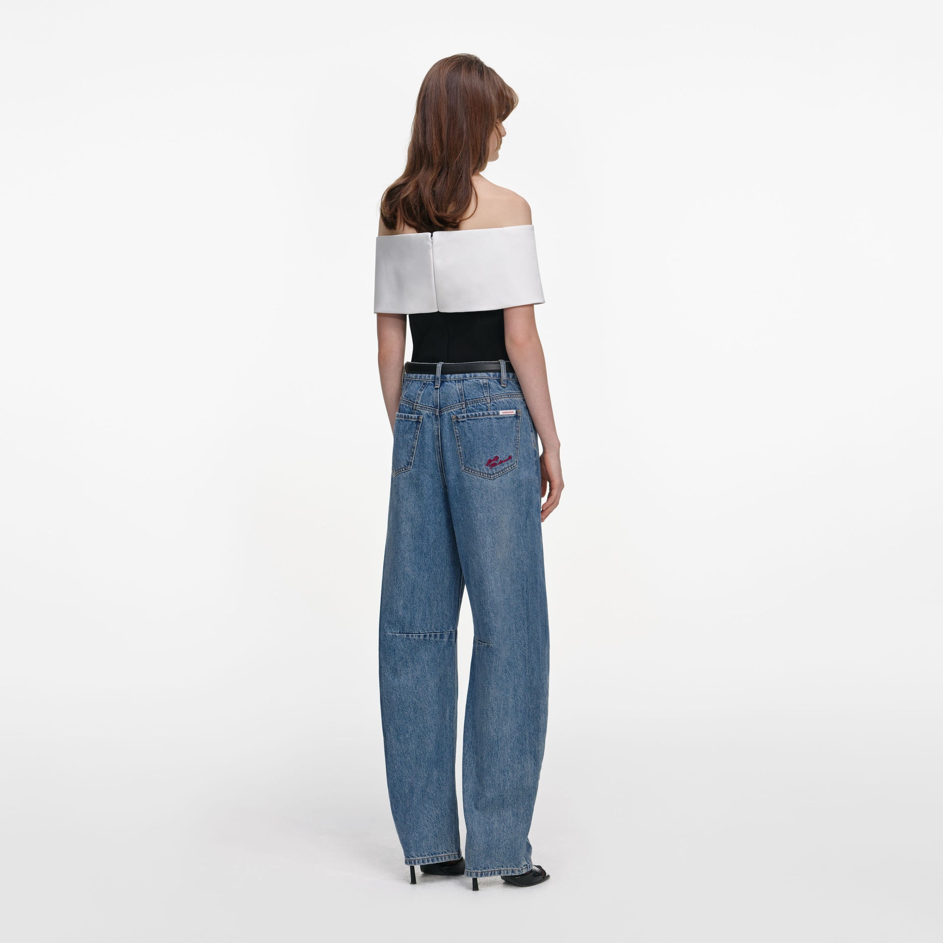 Back view of a woman wearing the Black Crepe Flower Top