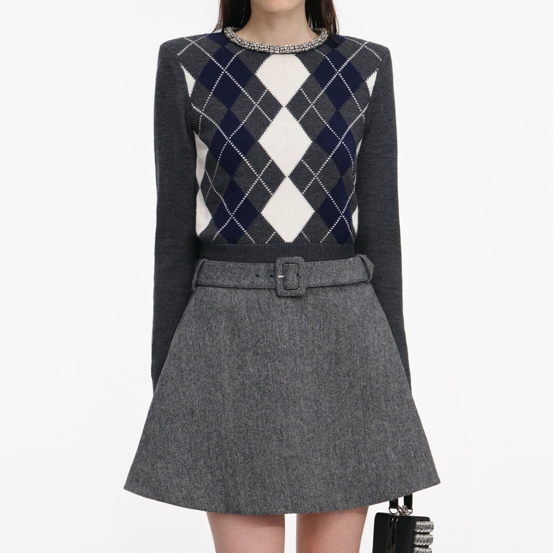 A close up of a woman wearing the Grey Herringbone Flared Mini Skirt