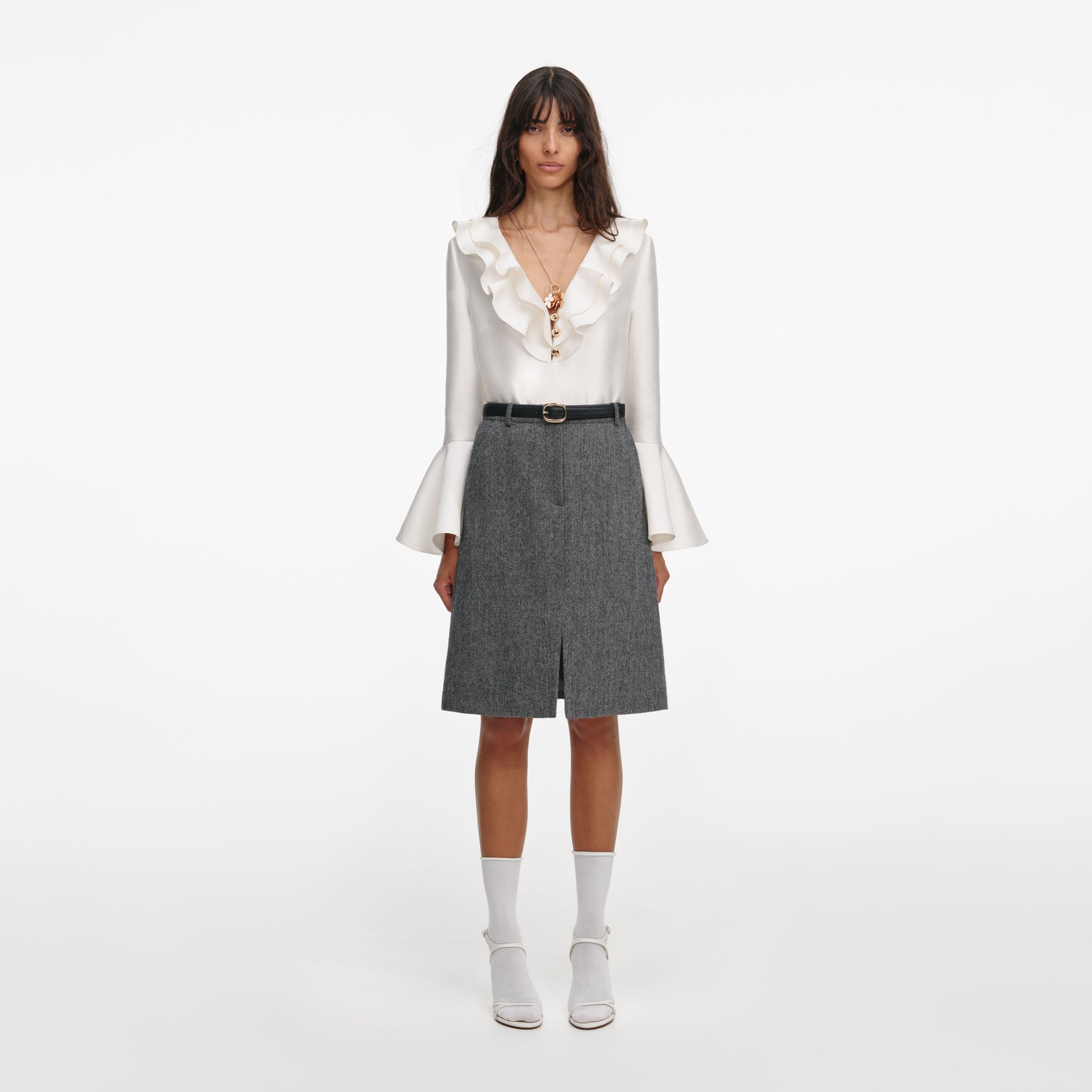 Front view of a woman wearing the Grey Herringbone Midi Skirt