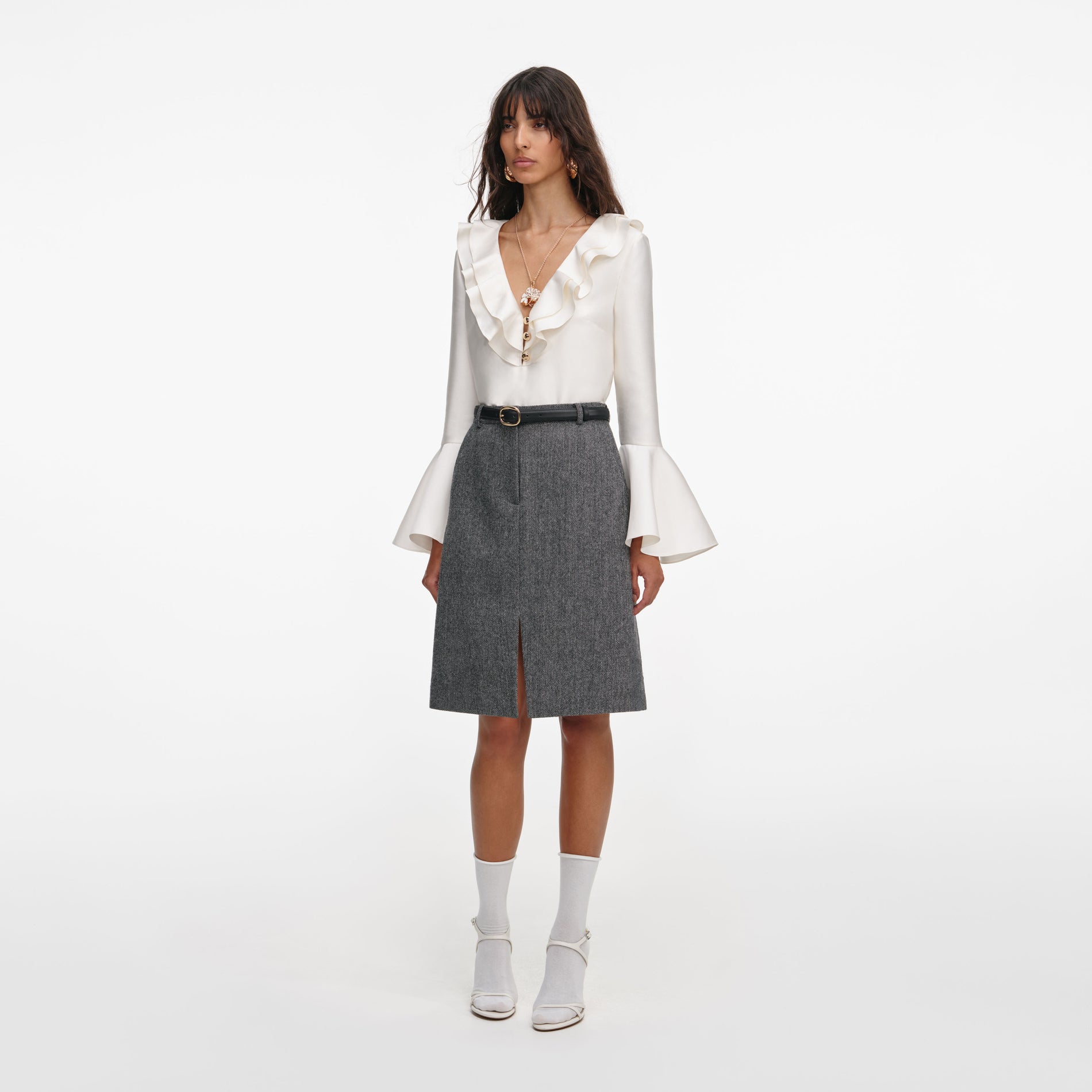 Side view of a woman wearing the Grey Herringbone Midi Skirt