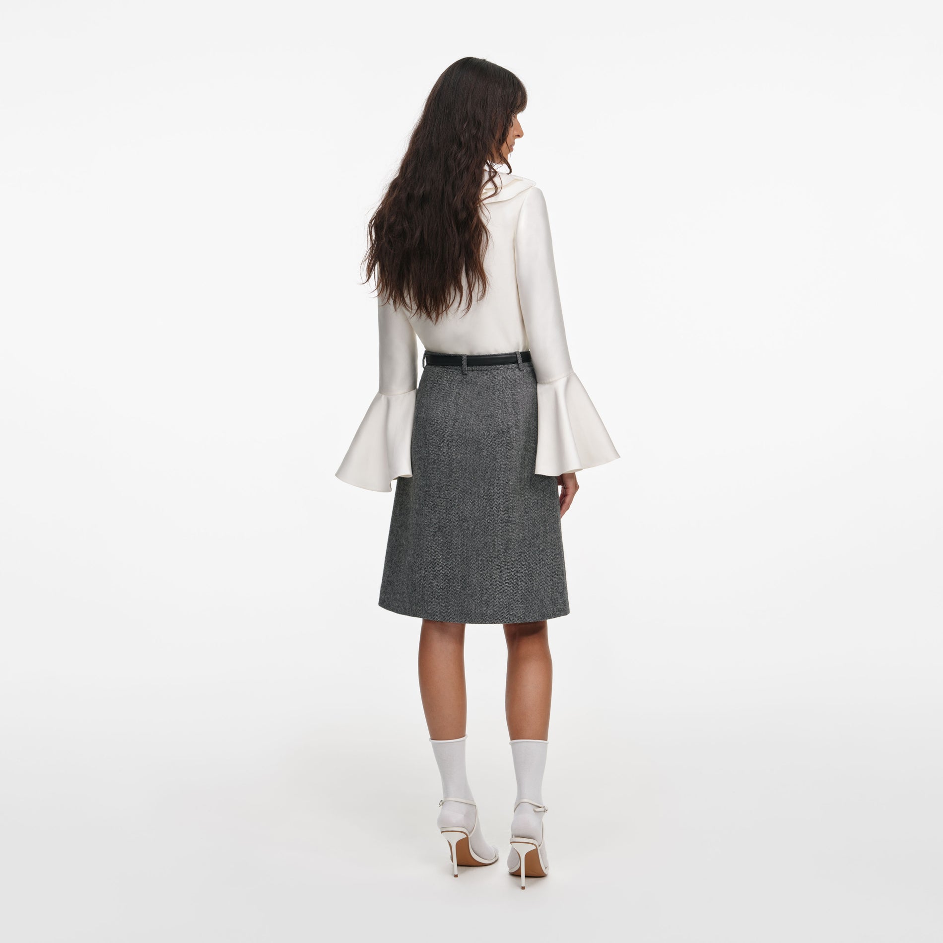 Back view of a woman wearing the Grey Herringbone Midi Skirt
