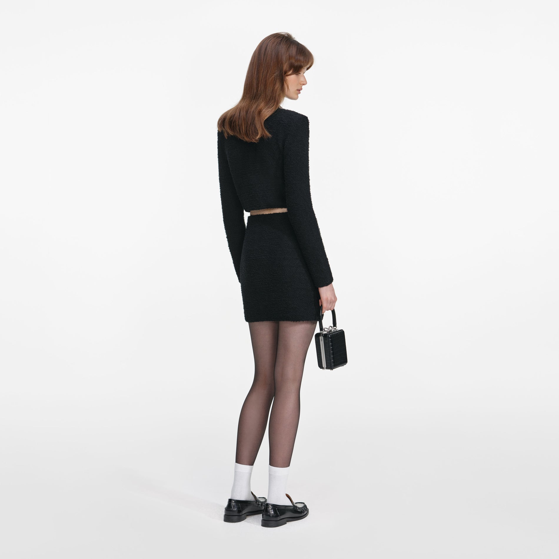 Back view of a woman wearing the Black Crystal Trim Cardigan