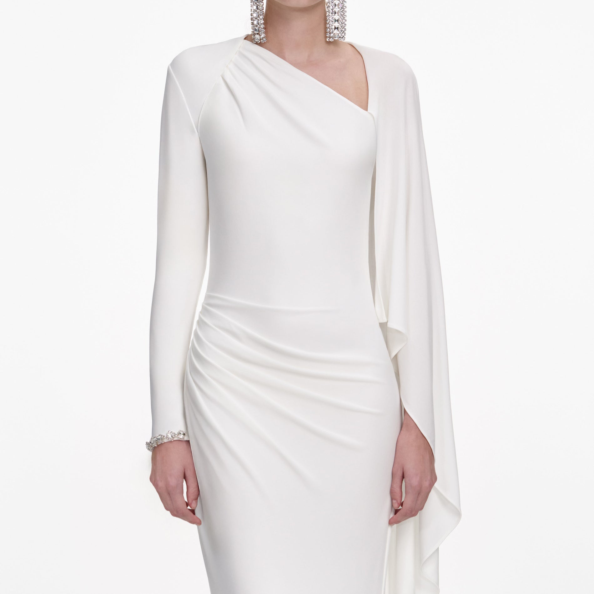 A close up of a woman wearing the White Jersey Drape Maxi Dress