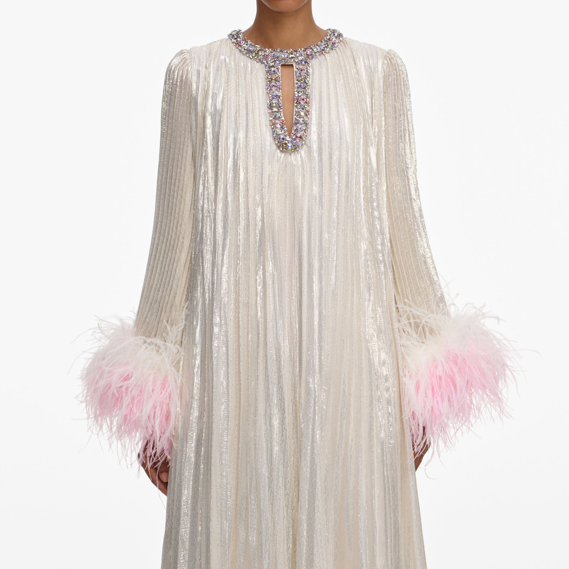 A close up of a woman wearing the Champagne Metallic Ombre Feather Maxi Dress