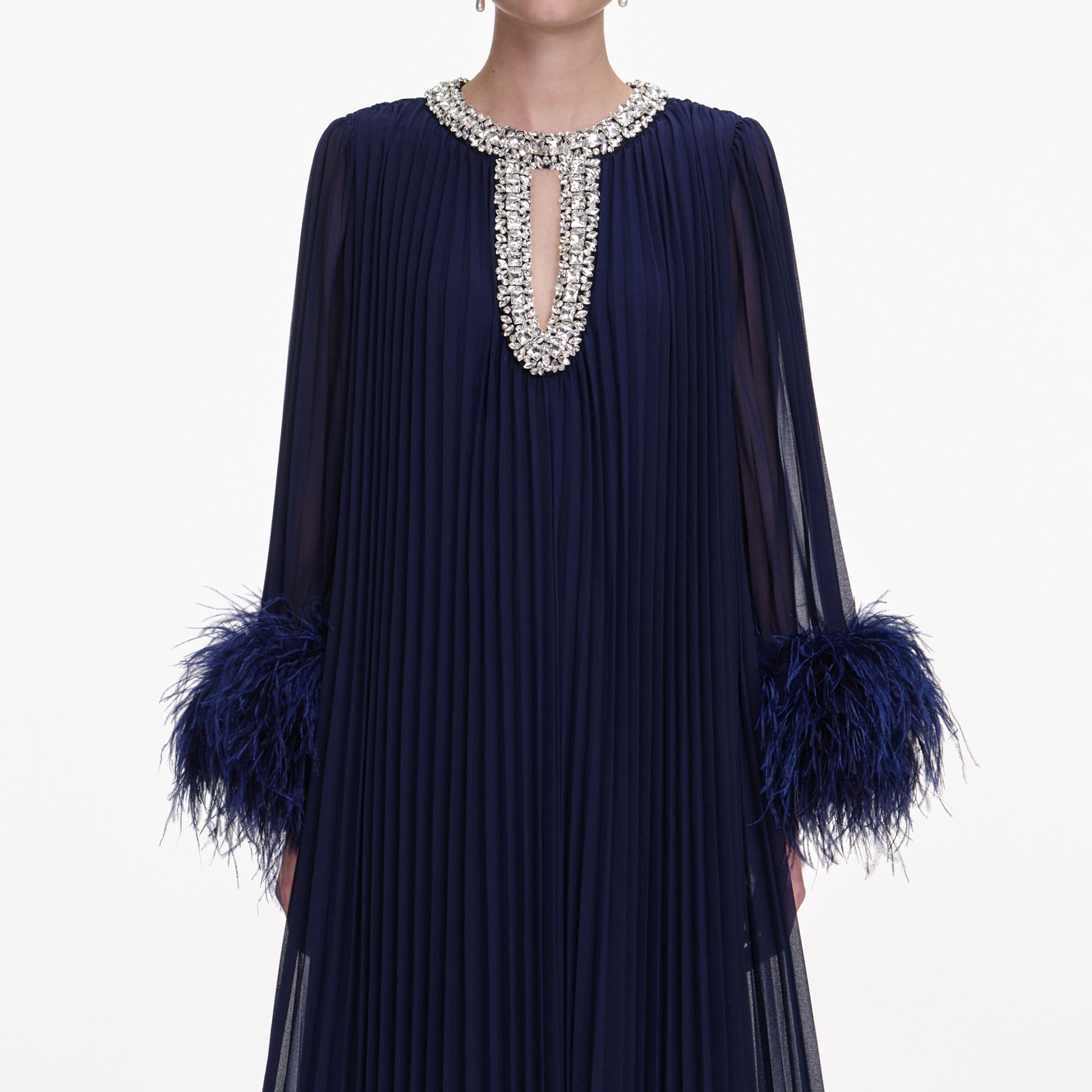 A close up of a woman wearing the Navy Chiffon Feather Midi Dress