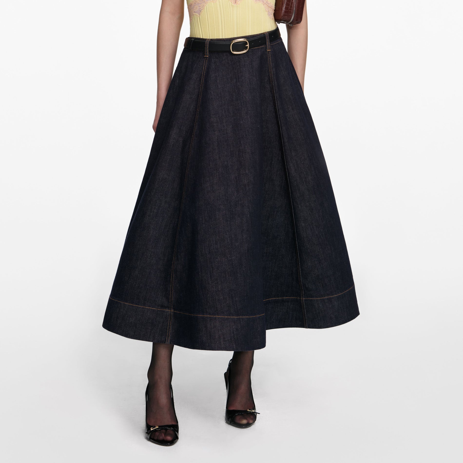 A close up of a woman wearing the Indigo Denim Flared Midi Skirt