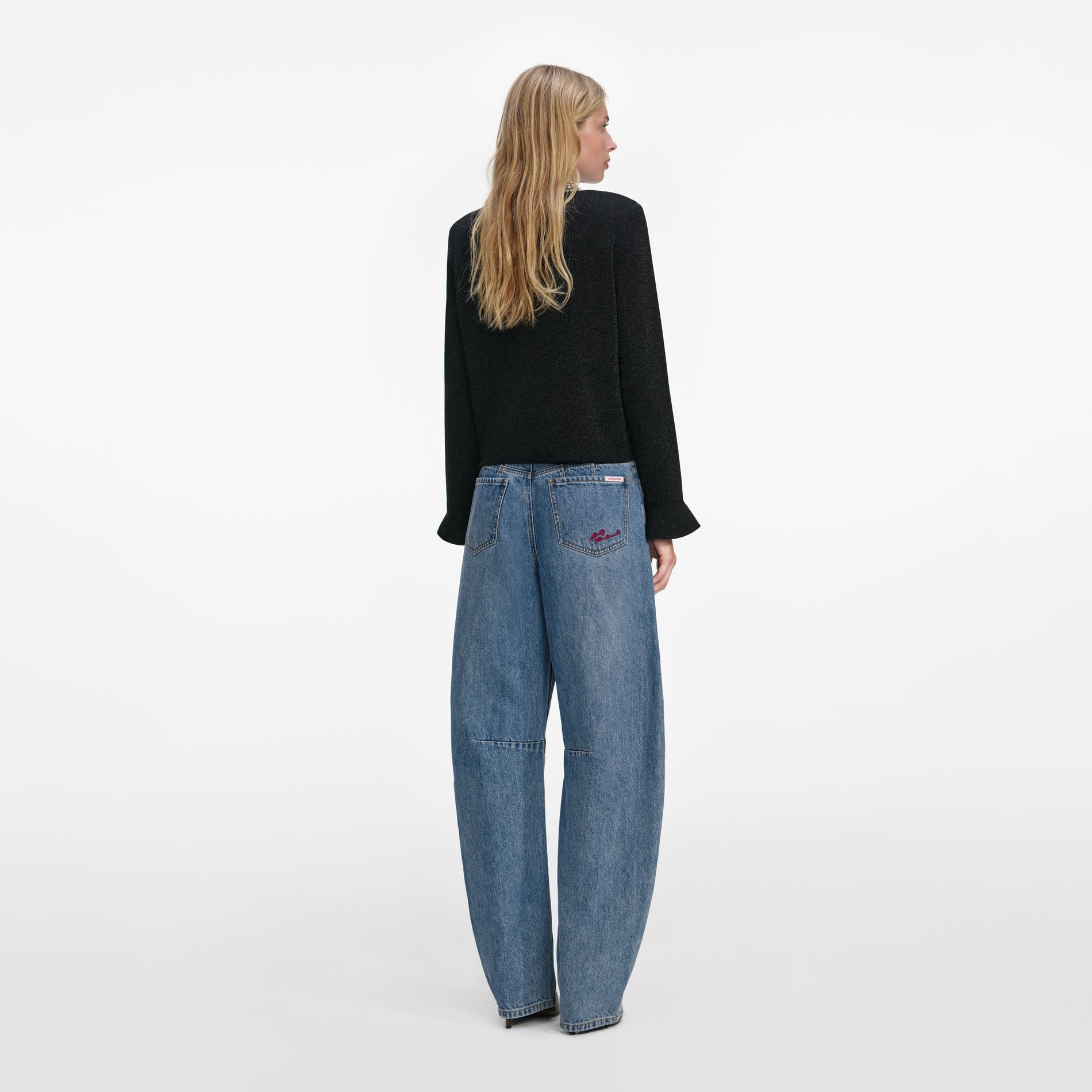 Back view of a woman wearing the Black Crystal Button Cardigan