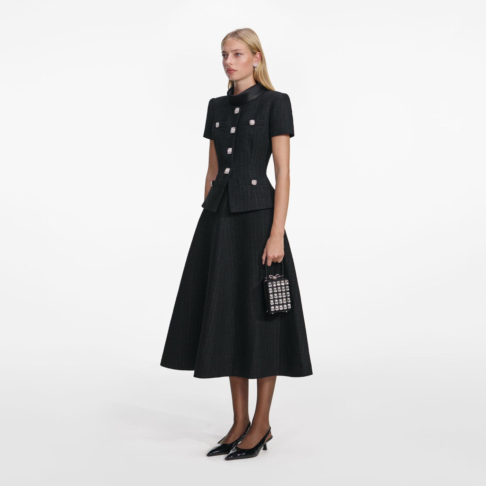 Side view of a woman wearing the Black Boucle Collared Midi Dress