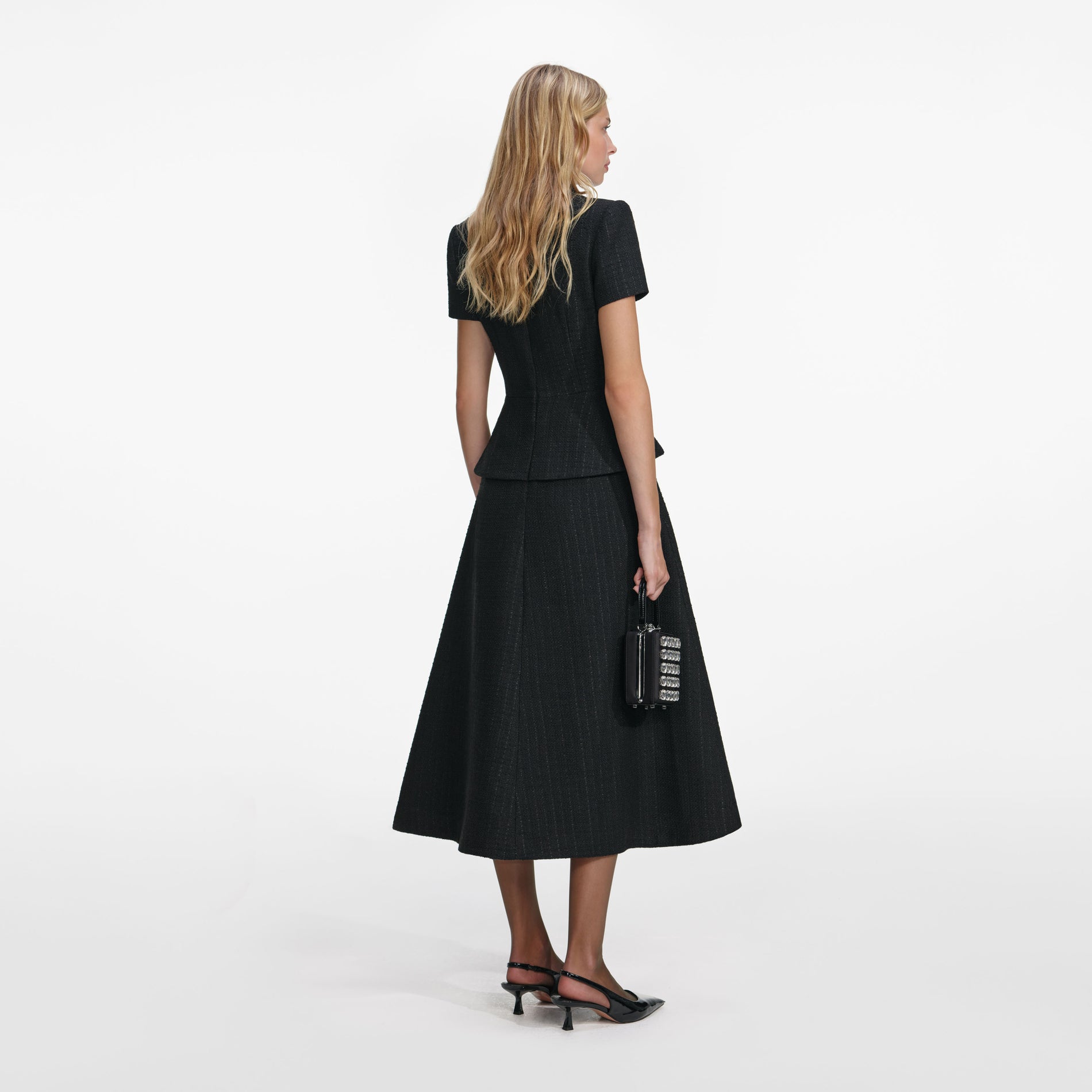 Back view of a woman wearing the Black Boucle Collared Midi Dress