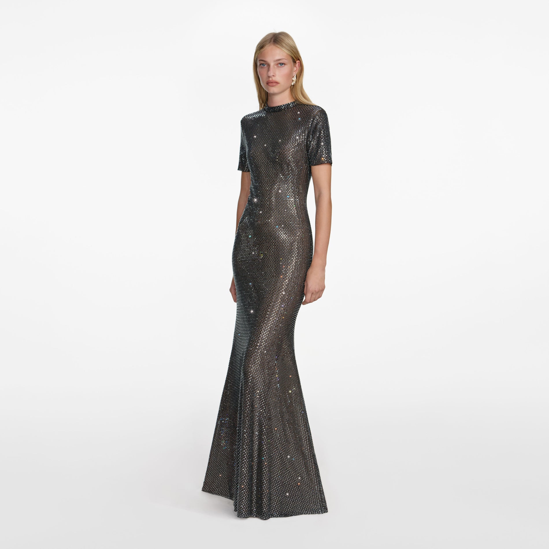 Side view of a woman wearing the Gunmetal Rhinestone Mesh Maxi Dress