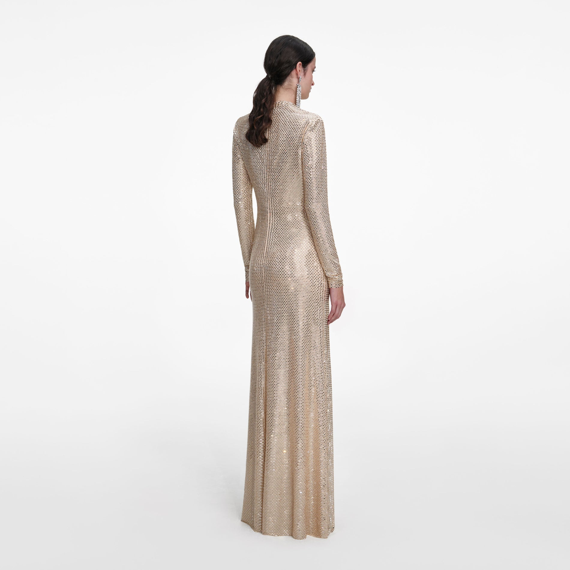 Back view of a woman wearing the Champagne Rhinestone Drape Maxi Dress