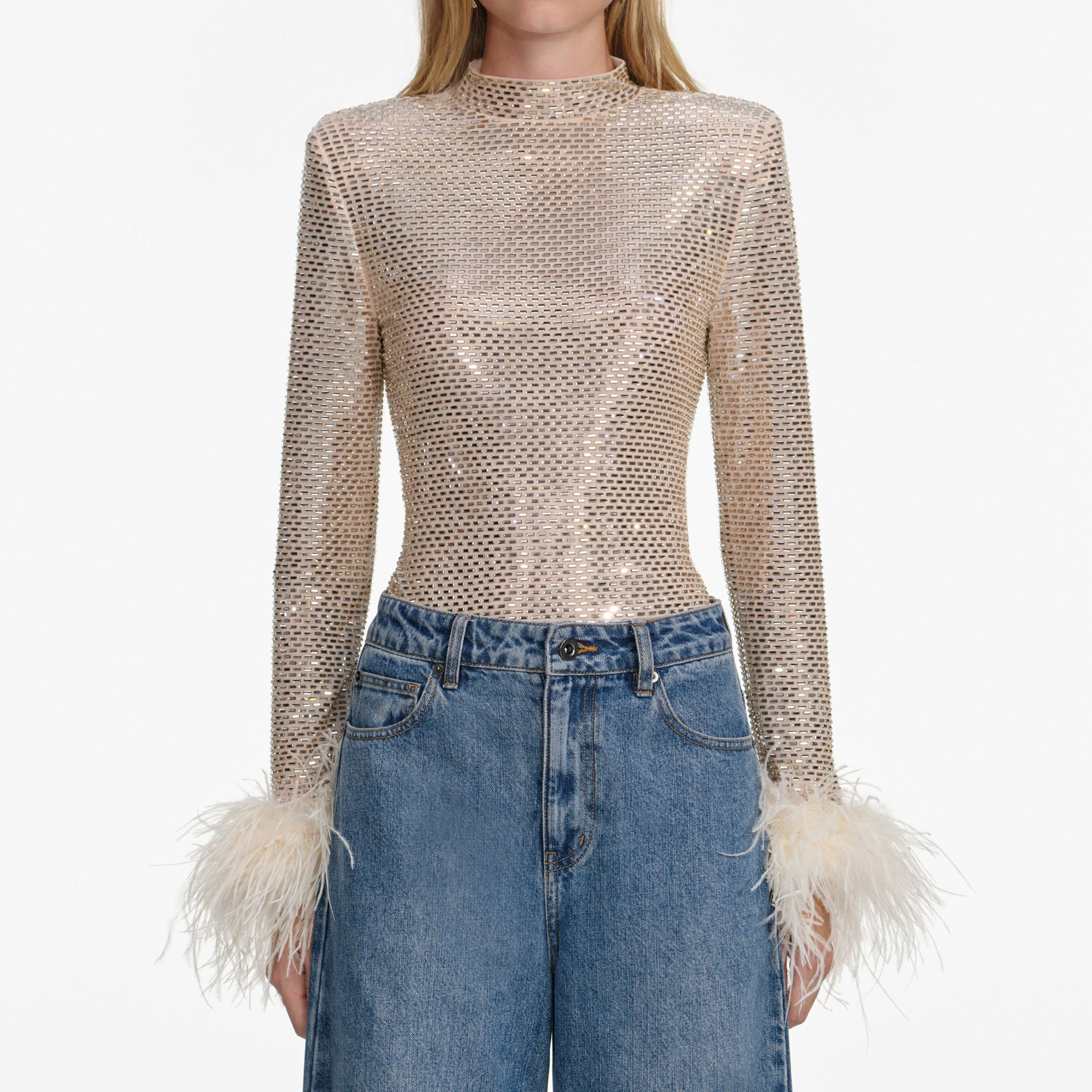 A close up of a woman wearing the Champagne Rhinestone Feather Top