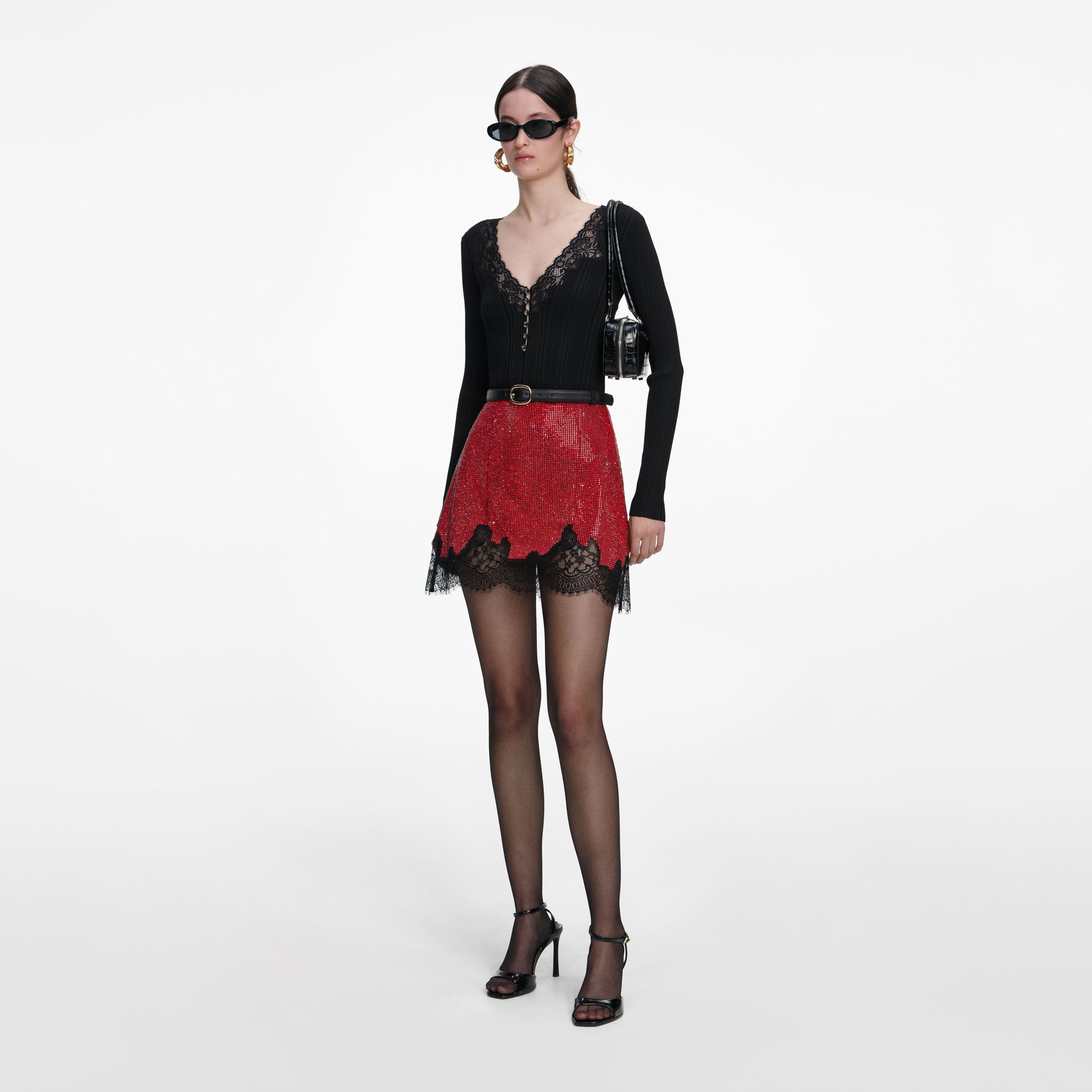 Side view of a woman wearing the Red Crystal Chainmail Mini Skirt