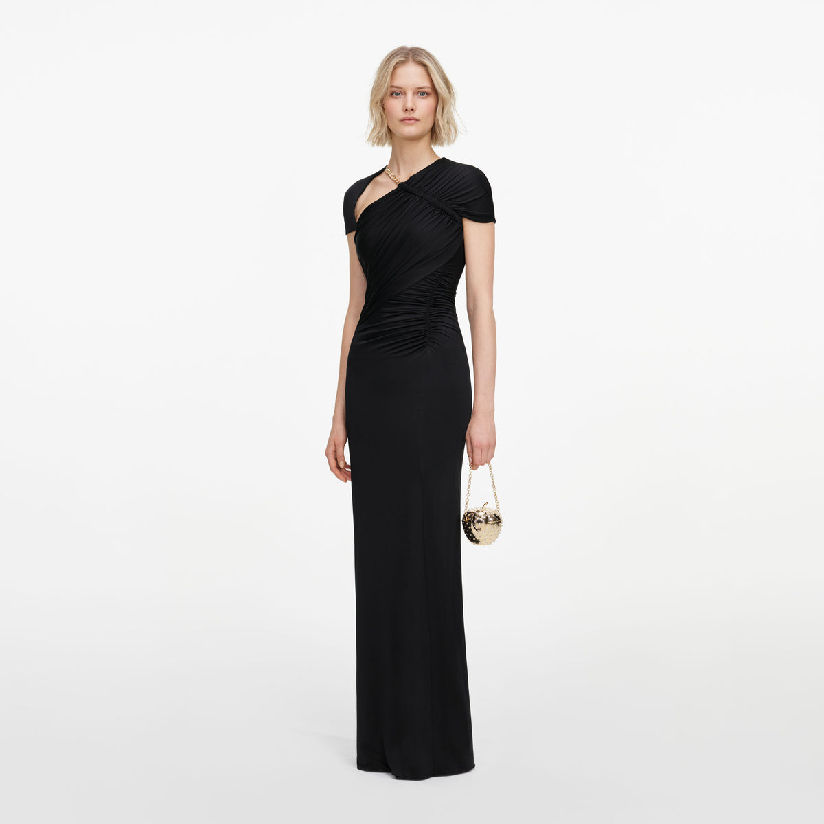 Side view of a woman wearing the Black Jersey Draped Maxi Dress