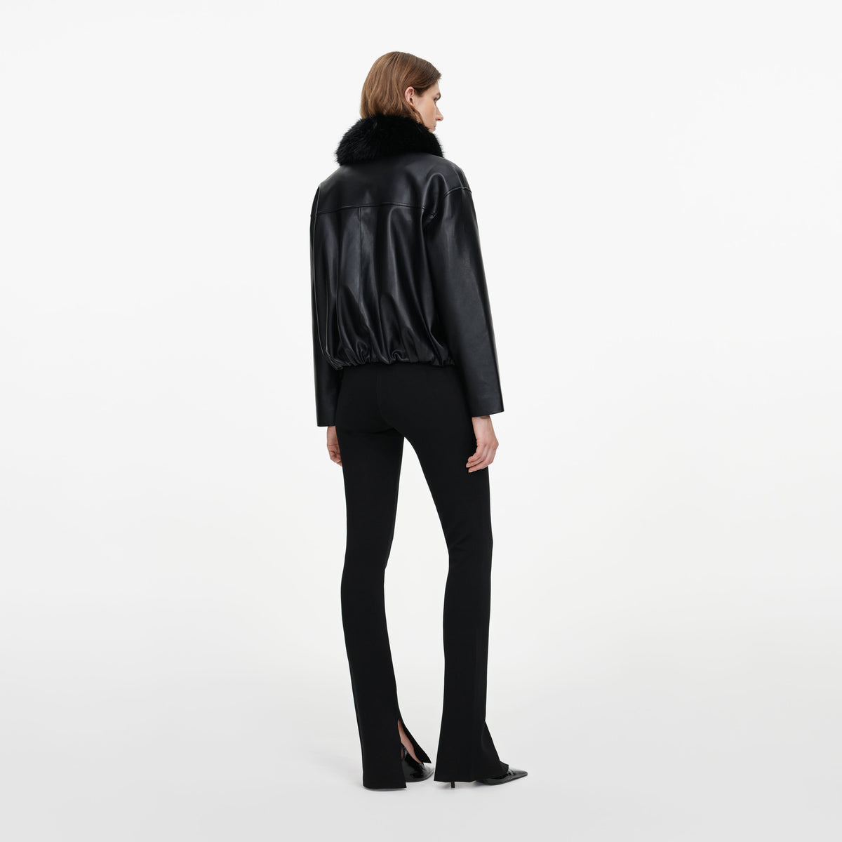 Back view of a woman wearing the Black Faux Leather Bomber Jacket