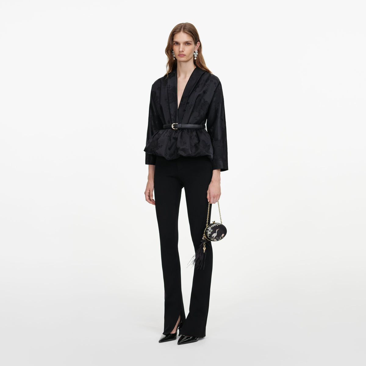 Side view of a woman wearing the Black Jacquard Peplum Top
