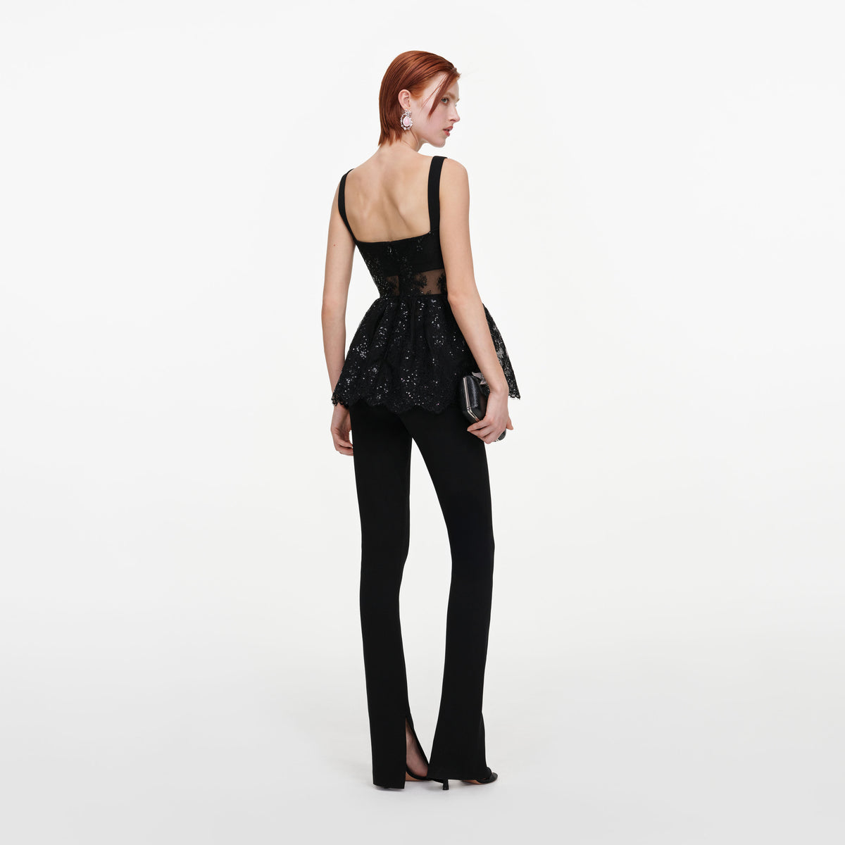 Back view of a woman wearing the Black Lace Peplum Top