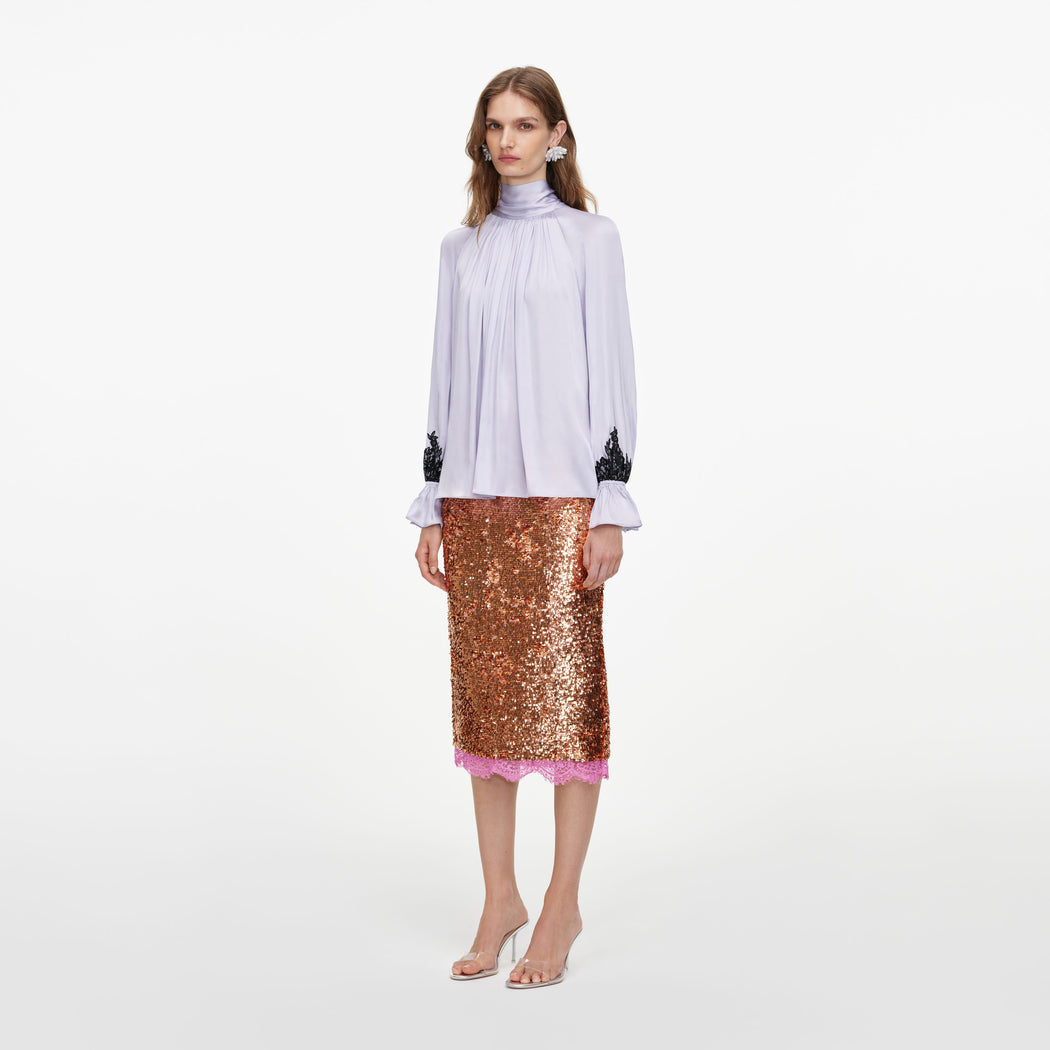 Side view of a woman wearing the Lilac Viscose Contrast Lace Blouse