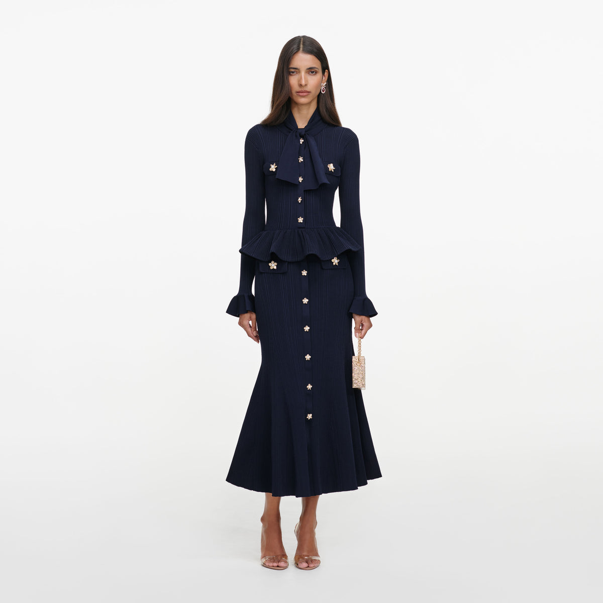 Front view of a woman wearing the Navy Peplum Knit Midi Dress