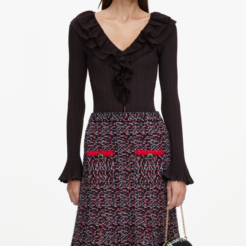 A close up of a woman wearing the Multi Textured Knit Midi Skirt