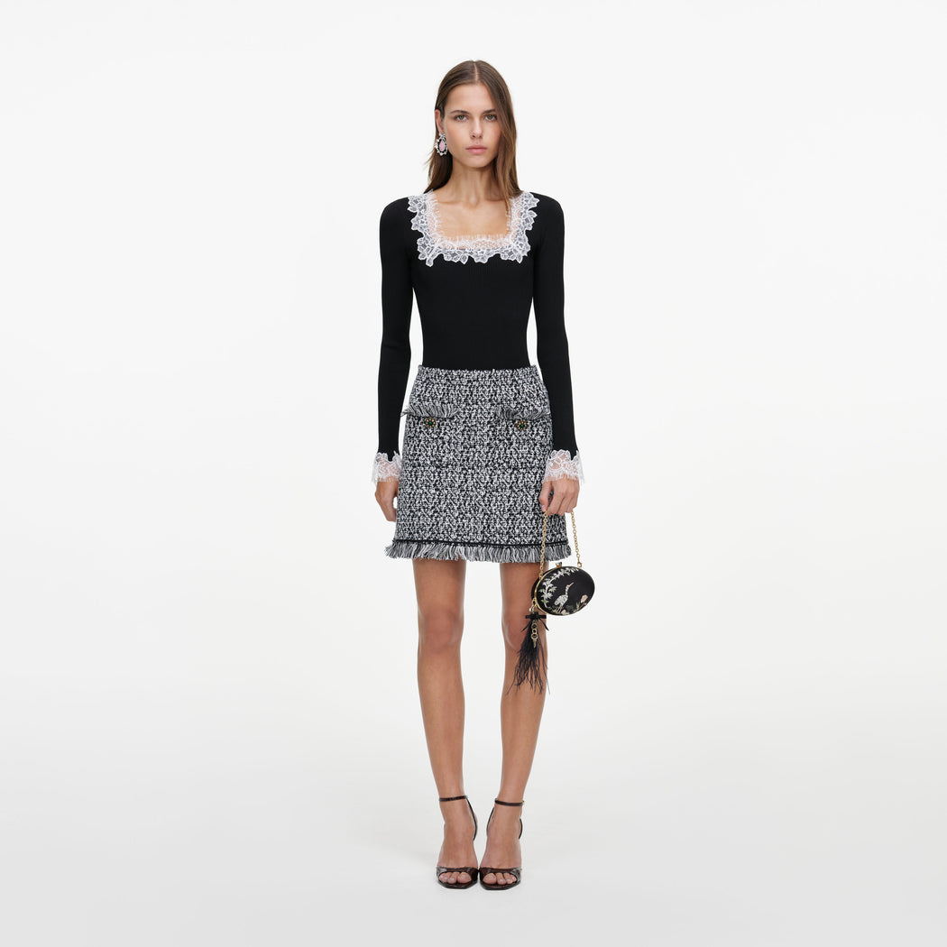 Front view of a woman wearing the Black And White Textured Knit Mini Skirt