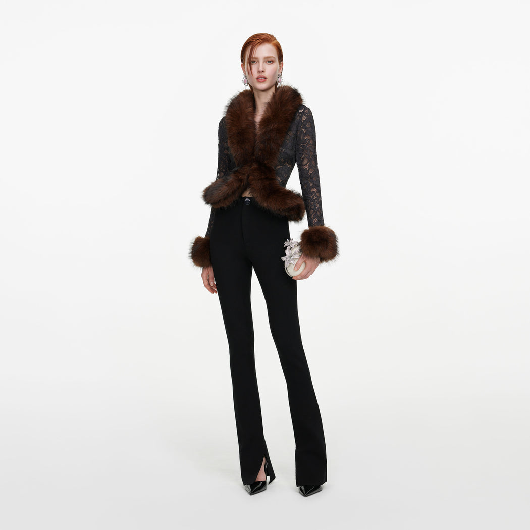 Front view of a woman wearing the Black Flared Knit Trousers