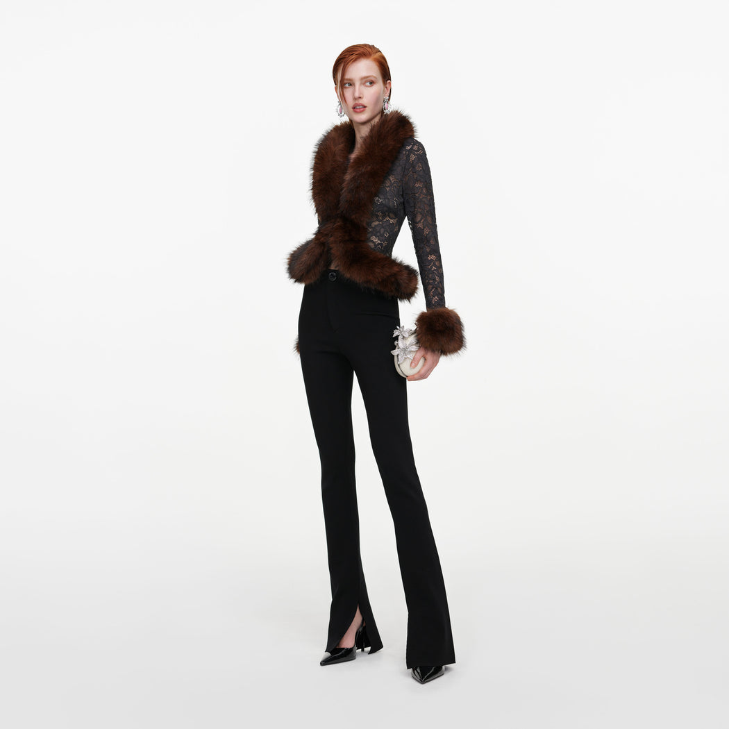 Side view of a woman wearing the Black Flared Knit Trousers