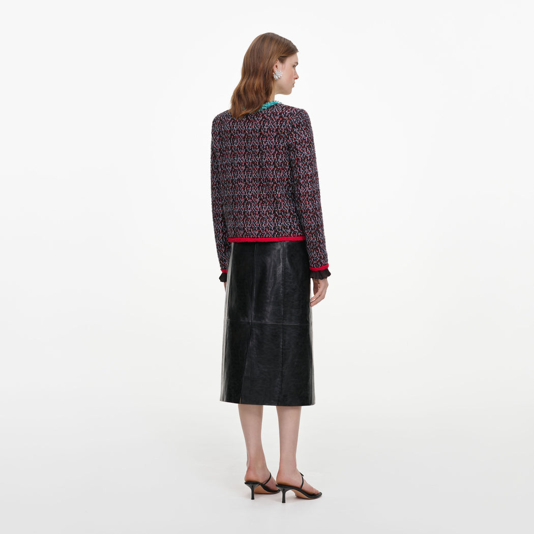 Back view of a woman wearing the Black Belted Faux Leather Midi Skirt
