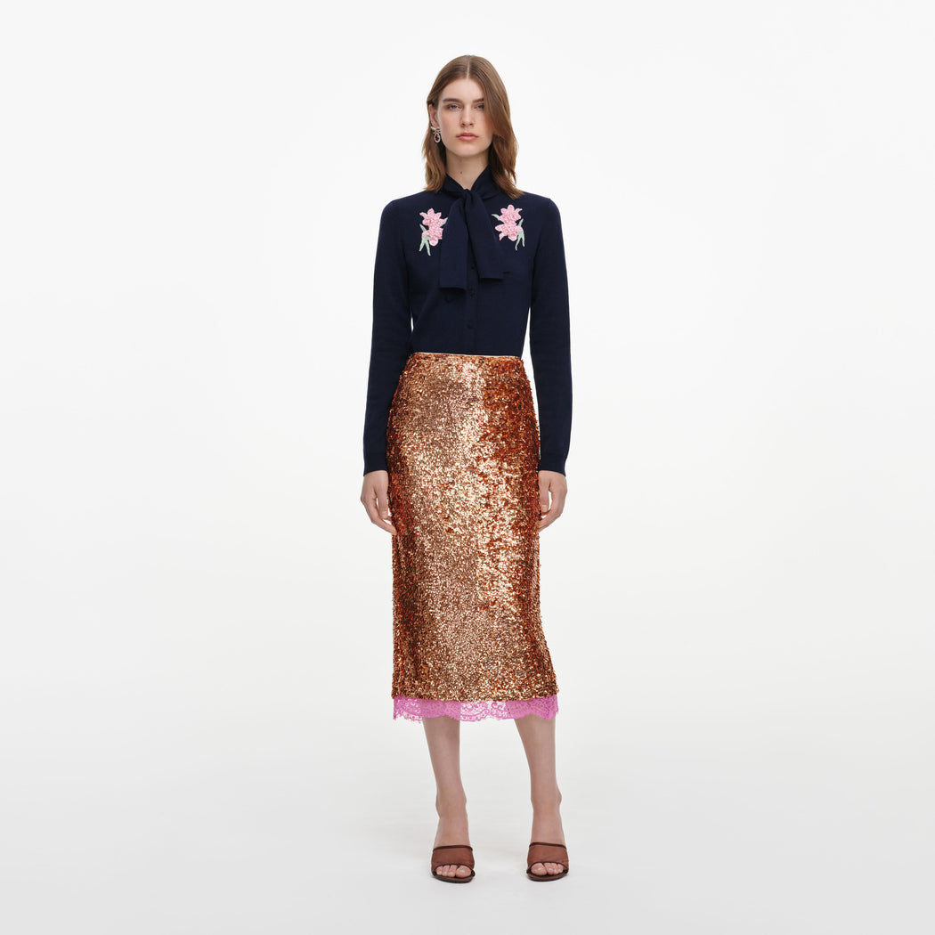 Front view of a woman wearing the Gold Sequin Midi Skirt