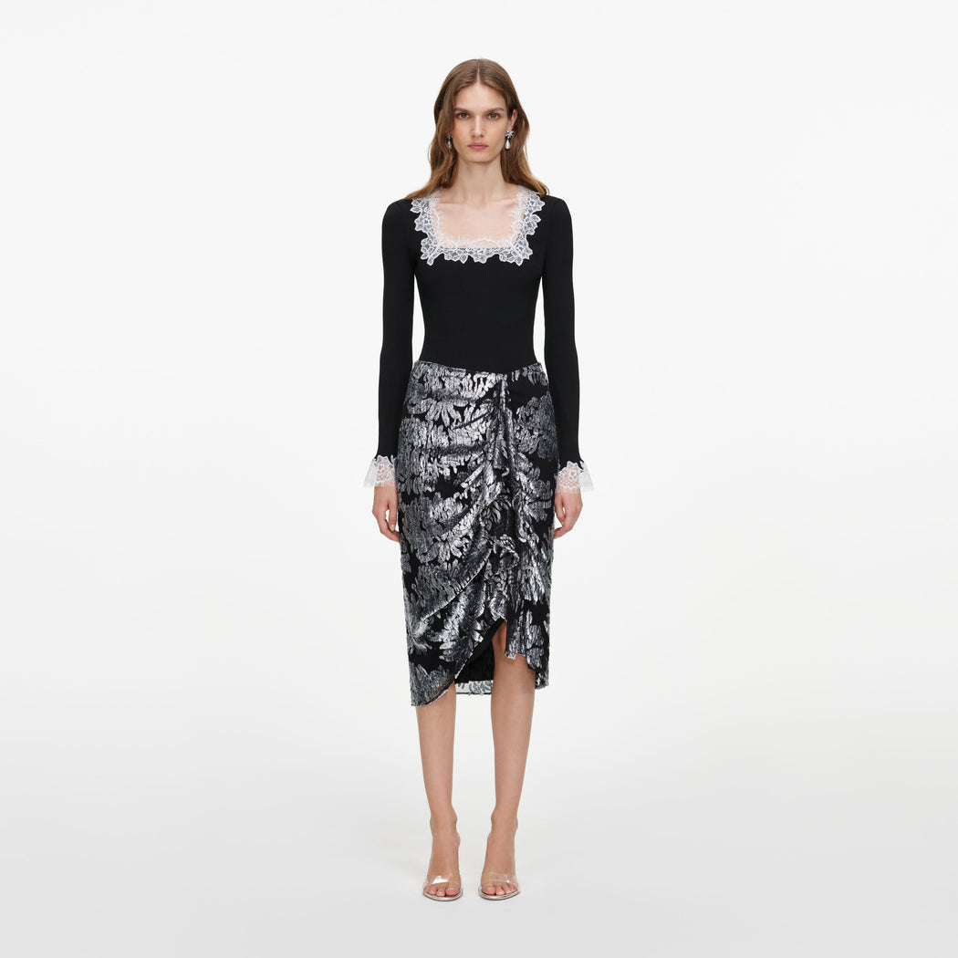 Front view of a woman wearing the Silver Fil Coupe Midi Skirt