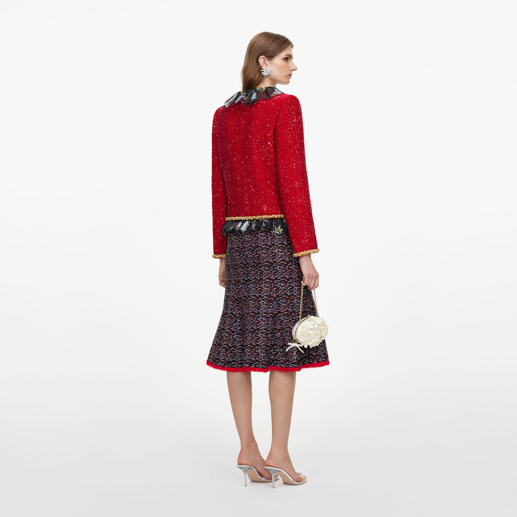 Back view of a woman wearing the Red Sequin Jacket